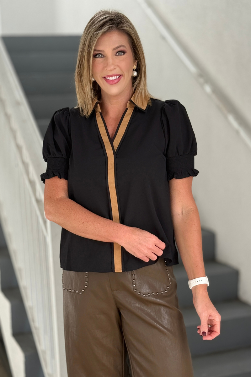 Women's black blouse with tan collar and V-neck trim