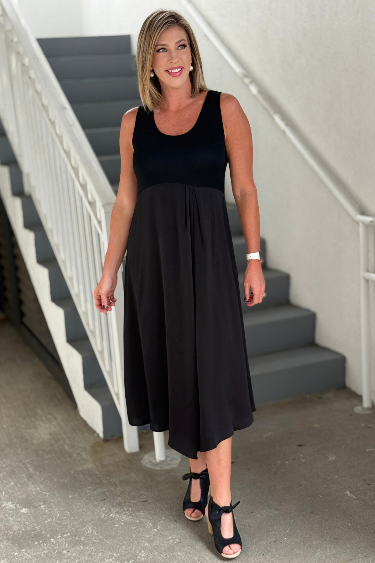 Black sleeveless midi dress with stretch knit bodice and satin skirt