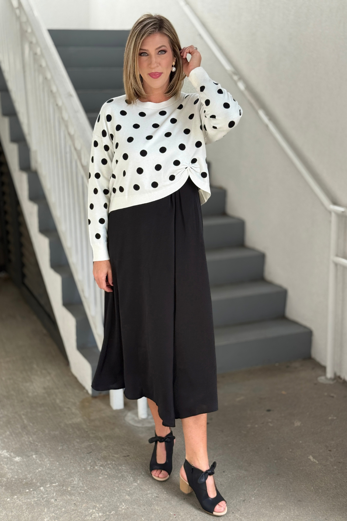 Women’s black satin midi dress styled for fall