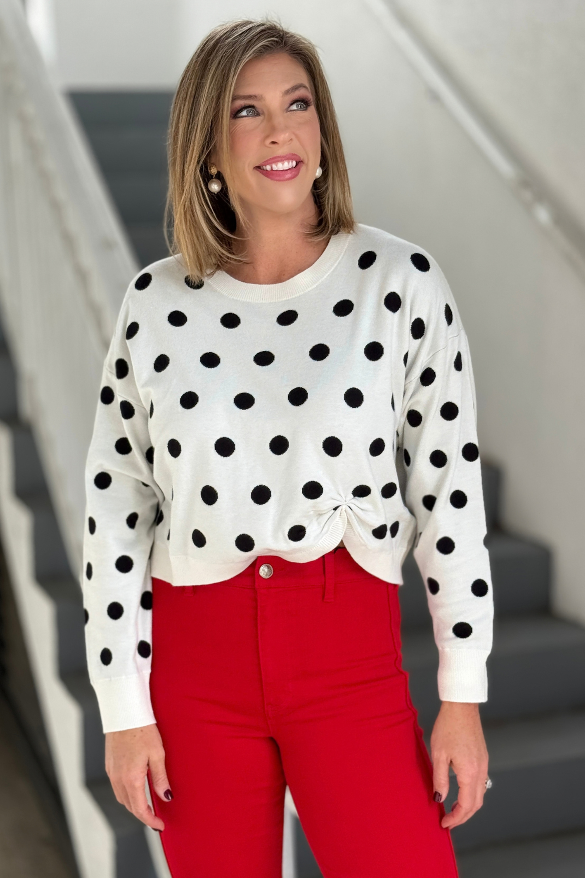 Ivory sweater with black polka dots and front knot detail