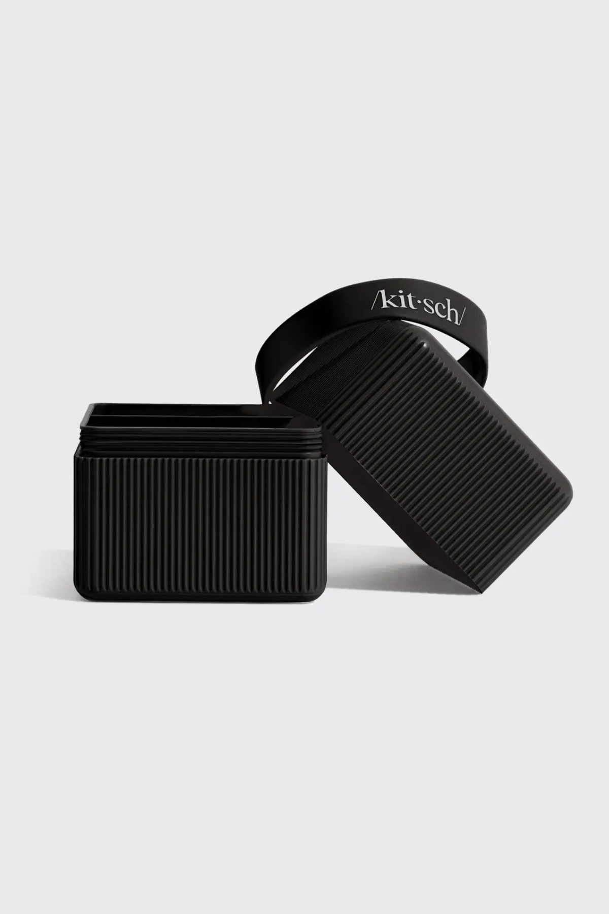 Black ribbed Kitsch travel case displayed with insert items