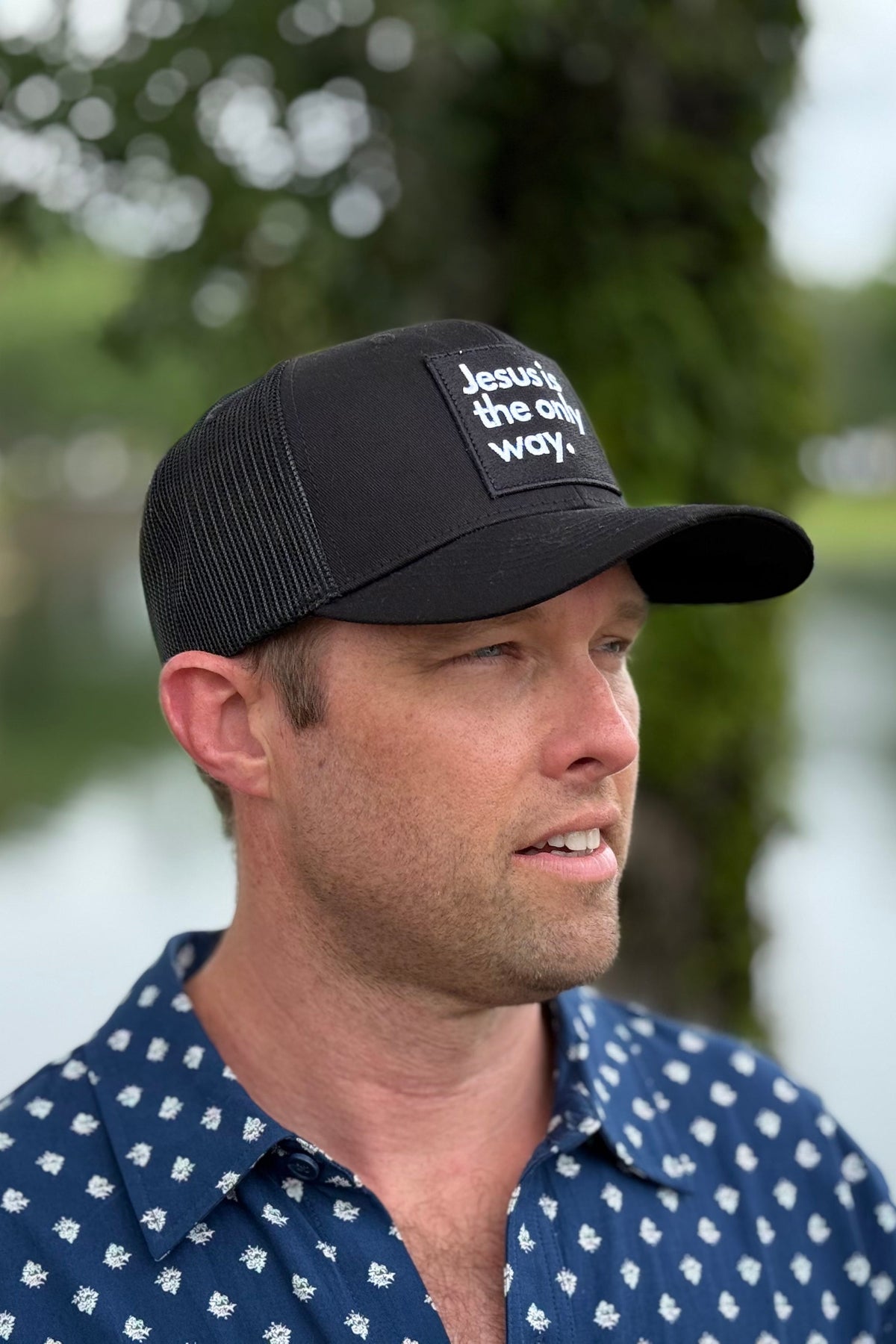 Man wearing Ball cap outside with head turned