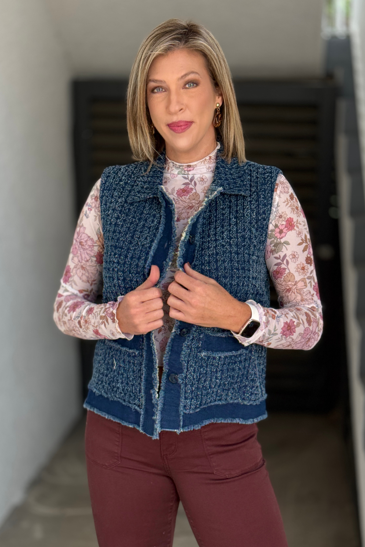 A La Carte button front denim vest layered over floral mesh top