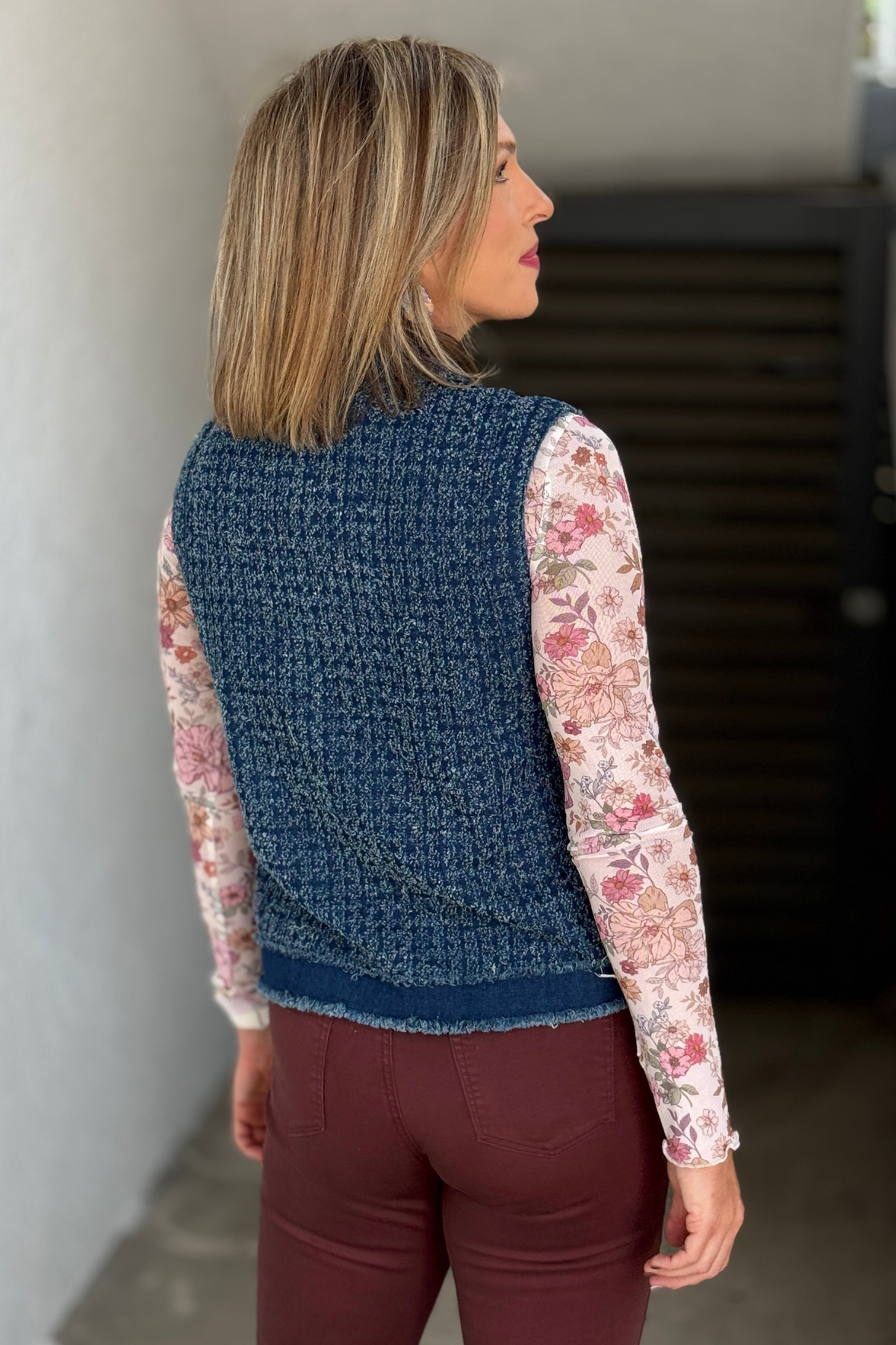 Textured blue denim vest with raw edge trim back view