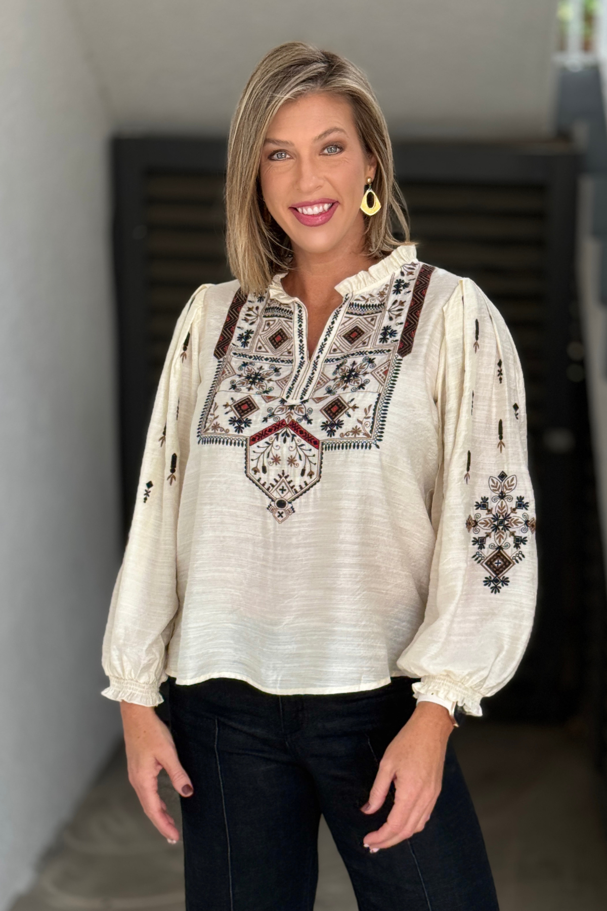 Cream embroidered blouse with ruffle collar and split neckline by A La Carte