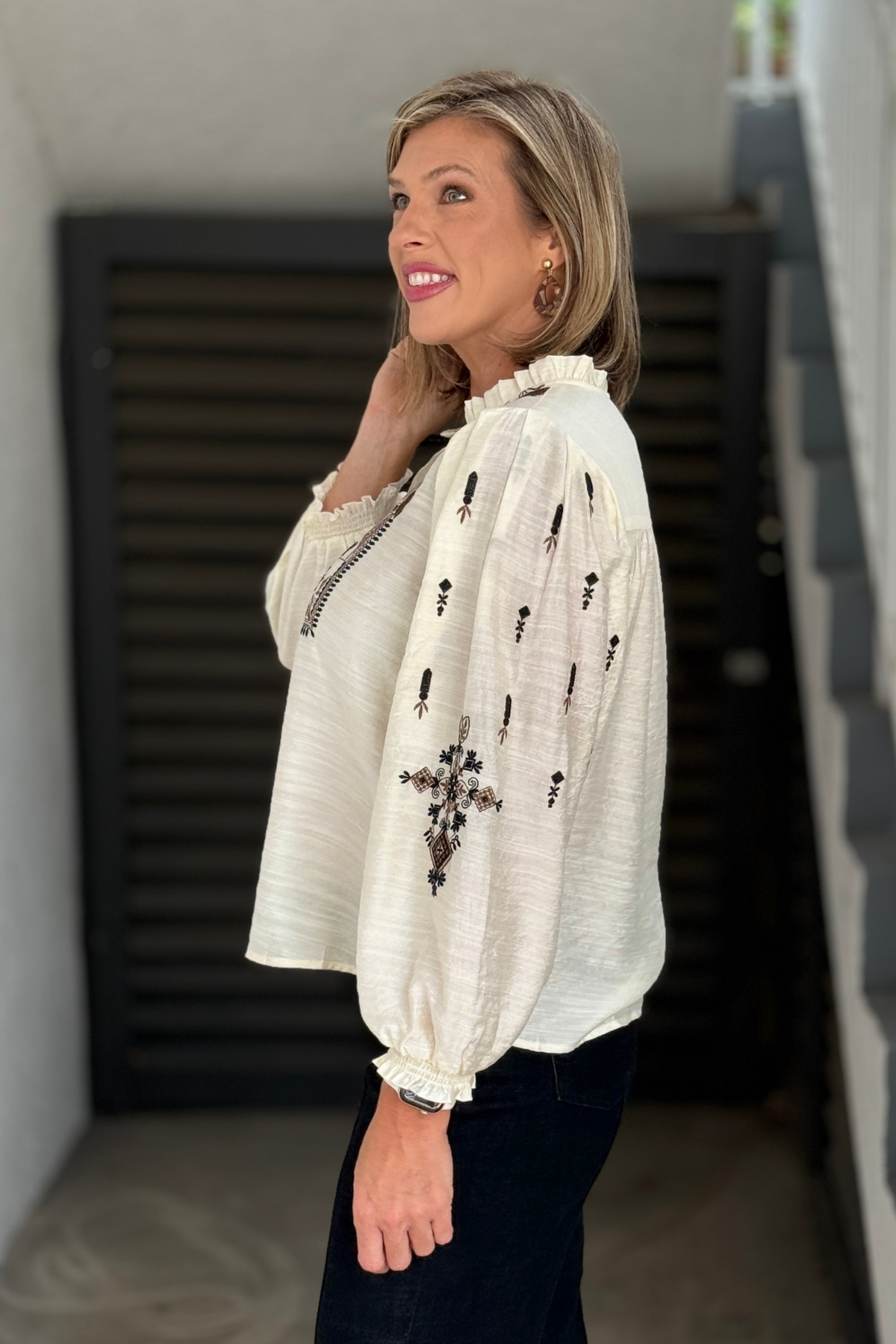 Back view of A La Carte cream embroidered popover blouse with relaxed fit