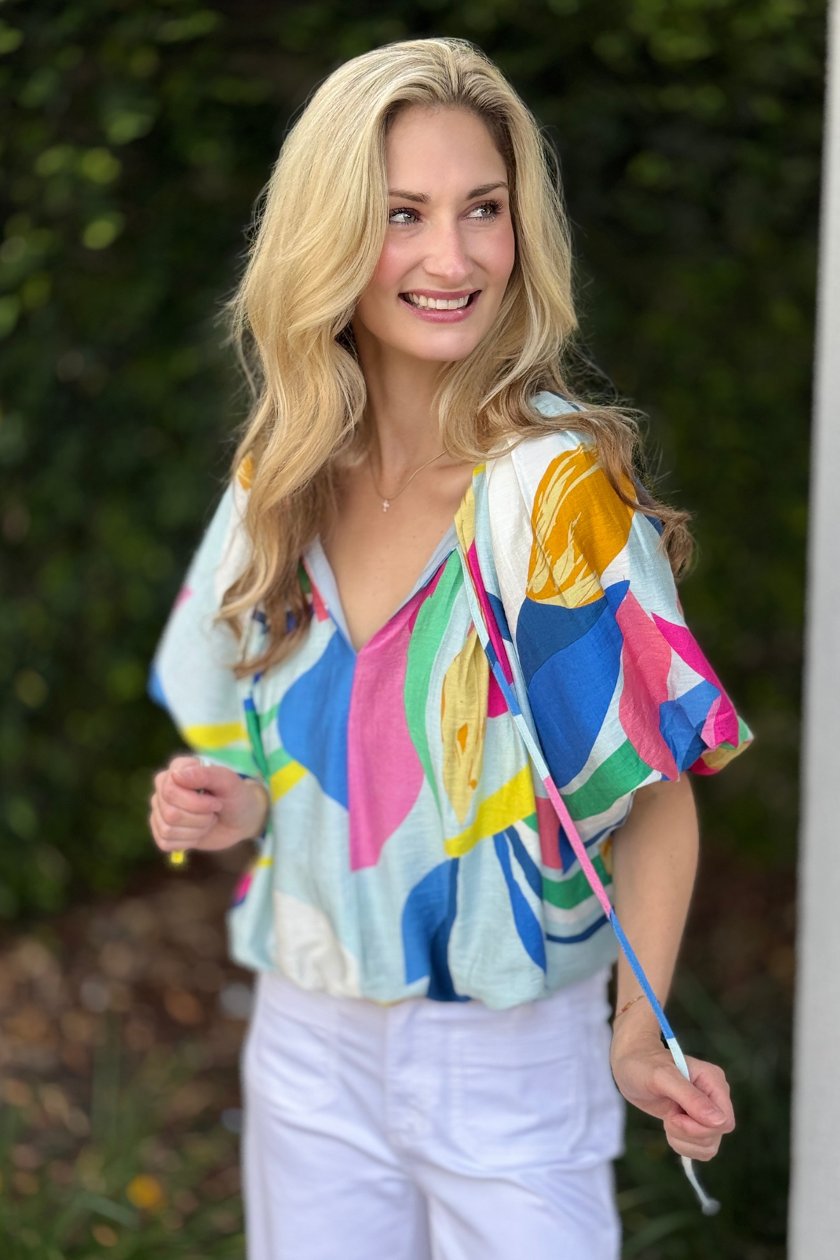 Back view of multicolor abstract lined summer blouse