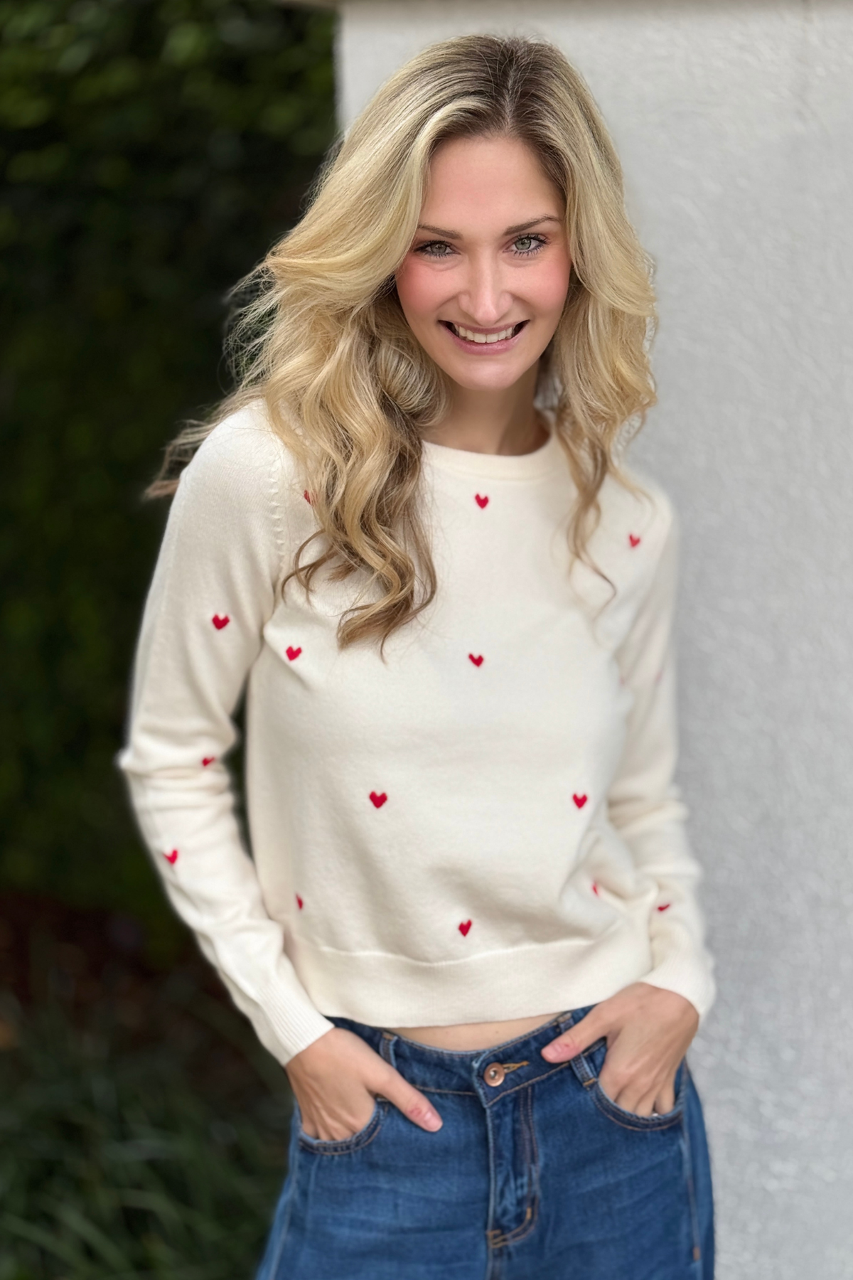 White embroidered heart sweater with red hearts front view
