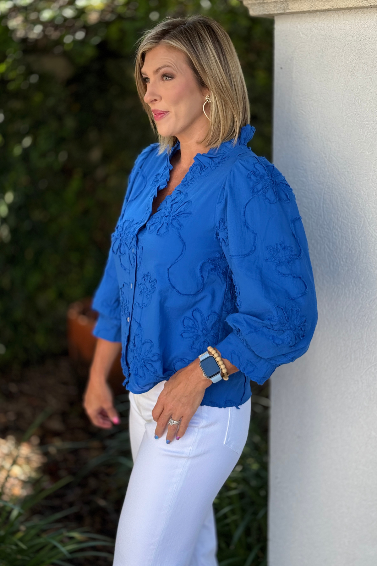 Side view of royal blue 3/4 sleeve floral blouse
