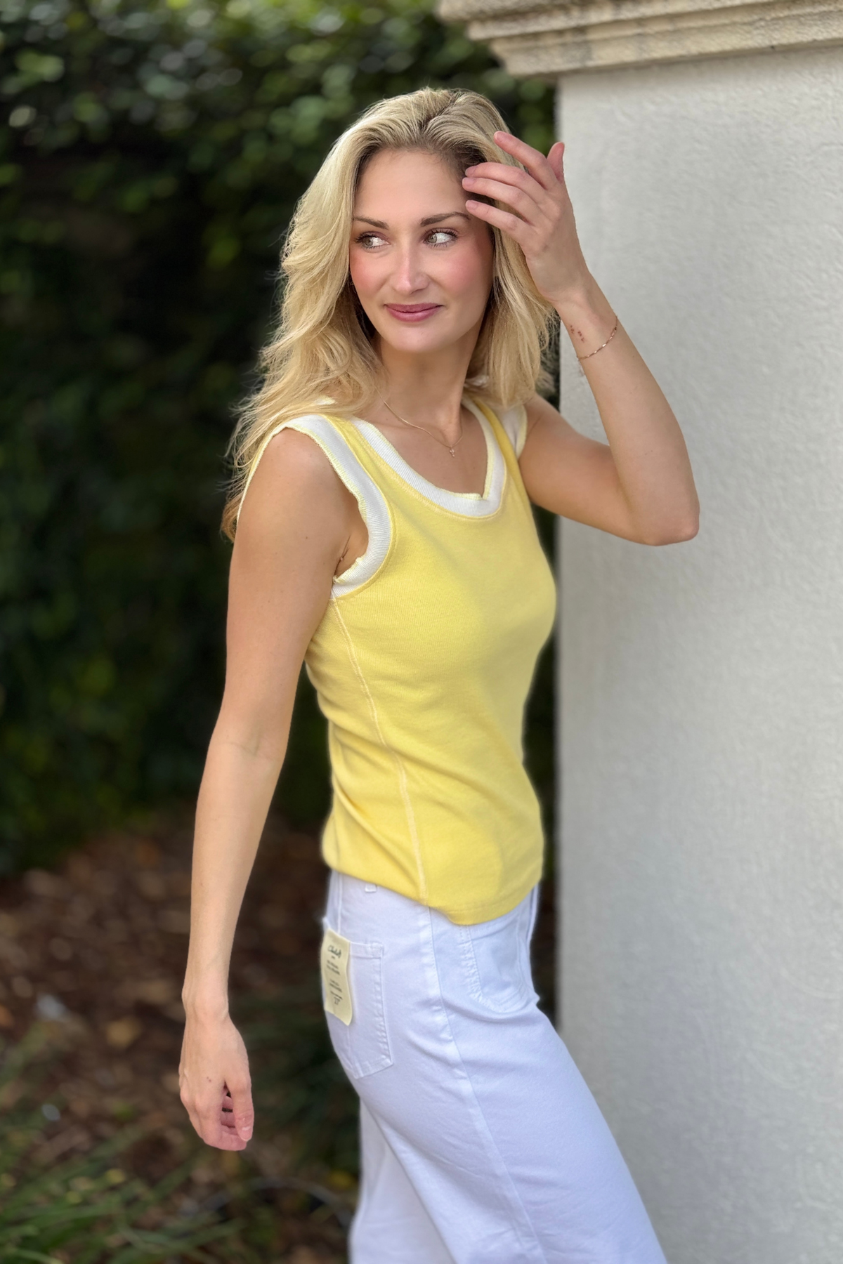 Back view of banana yellow sleeveless knit top
