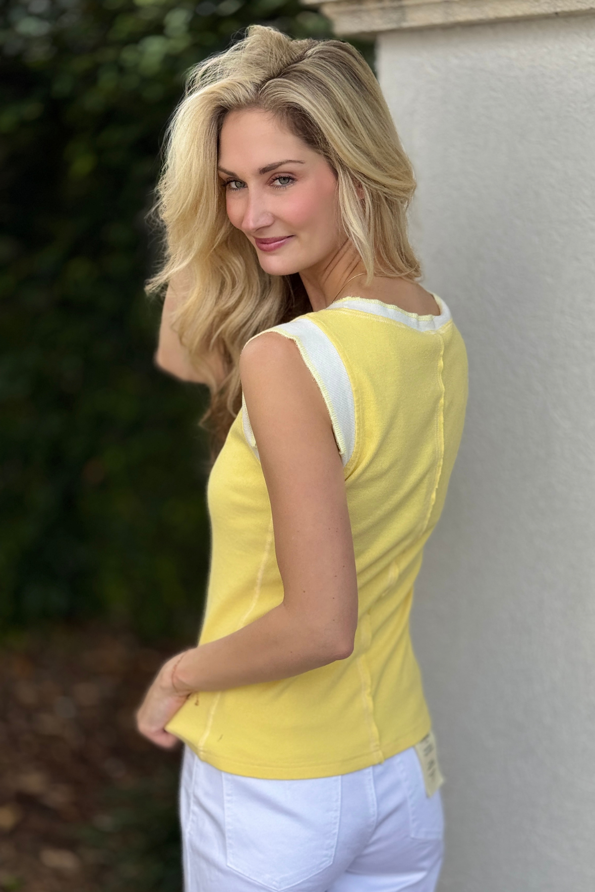 Close up of yellow layering tank with contrast trim