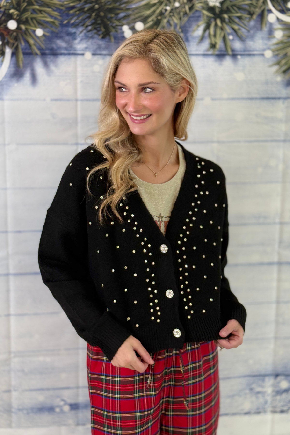 Black dressy cardigan styled with plaid holiday pants