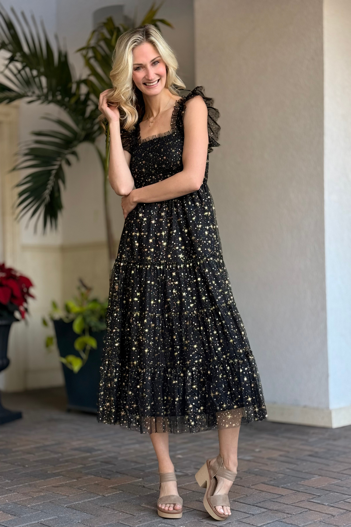 Woman wearing The Cosmic Shimmer Mesh Dress black and gold mesh midi