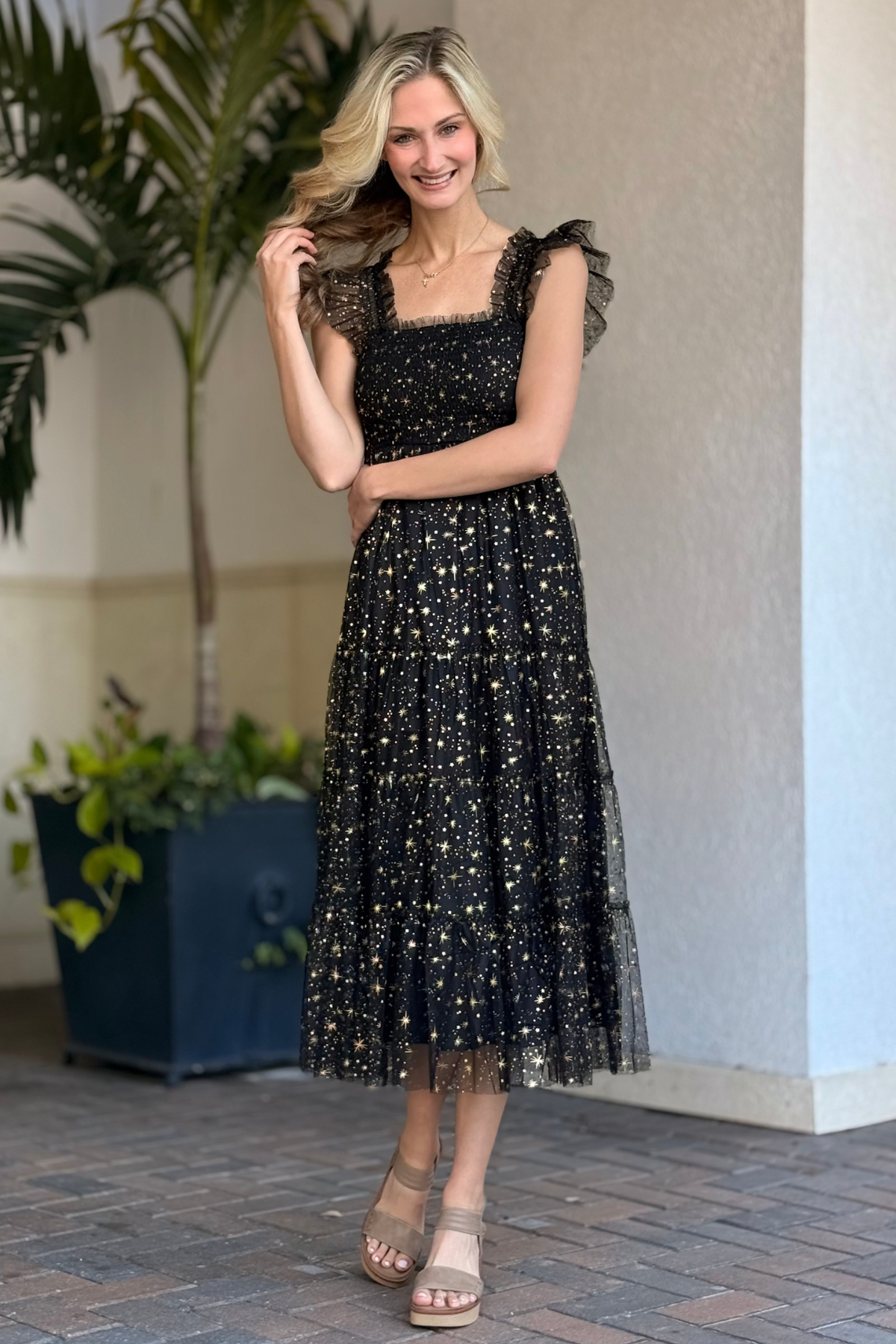 Gold star and moon accents on mesh midi dress close-up