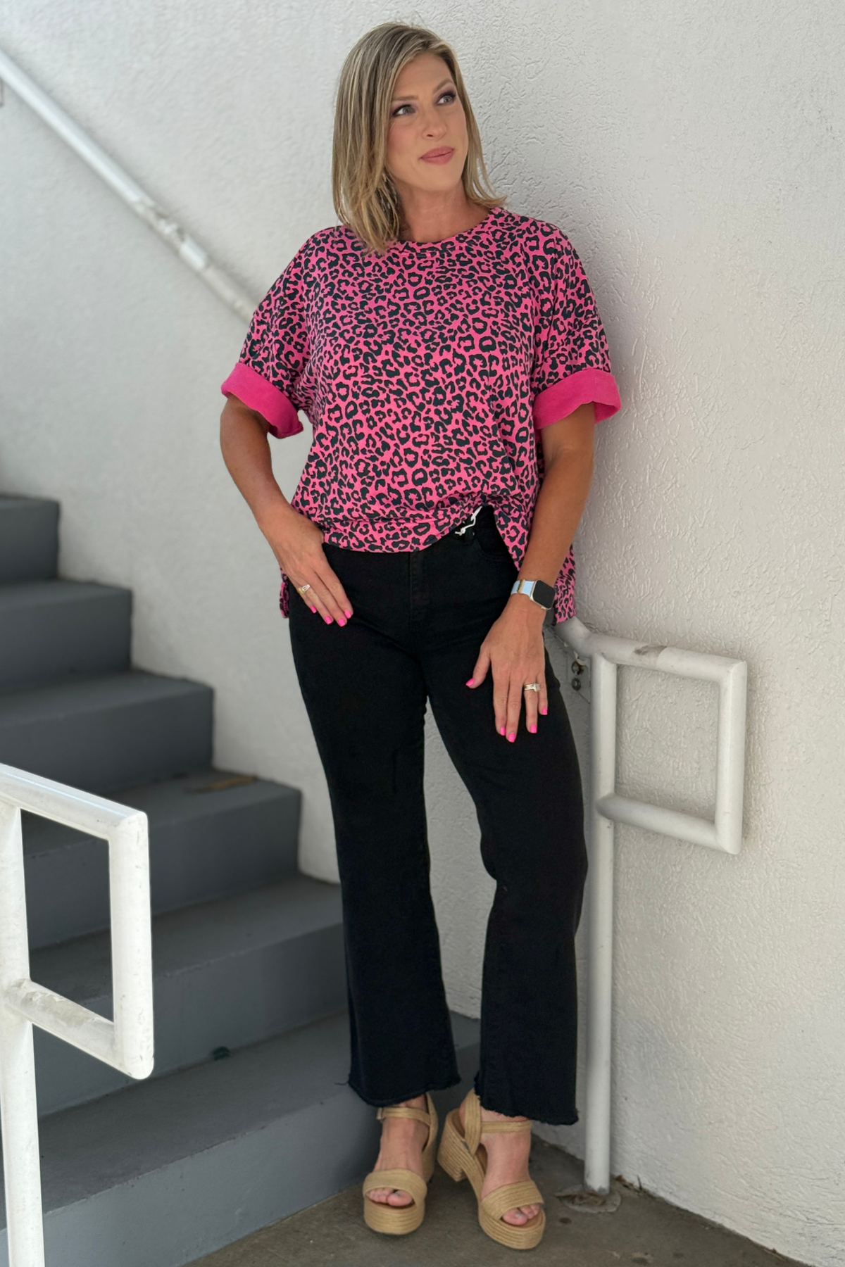 Woman wearing black wide leg cropped jeans with leopard print top