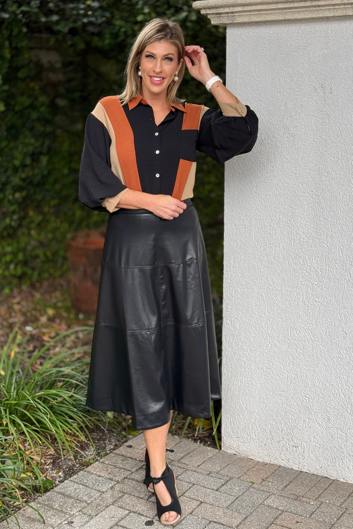 Black vegan leather A-line midi skirt front view