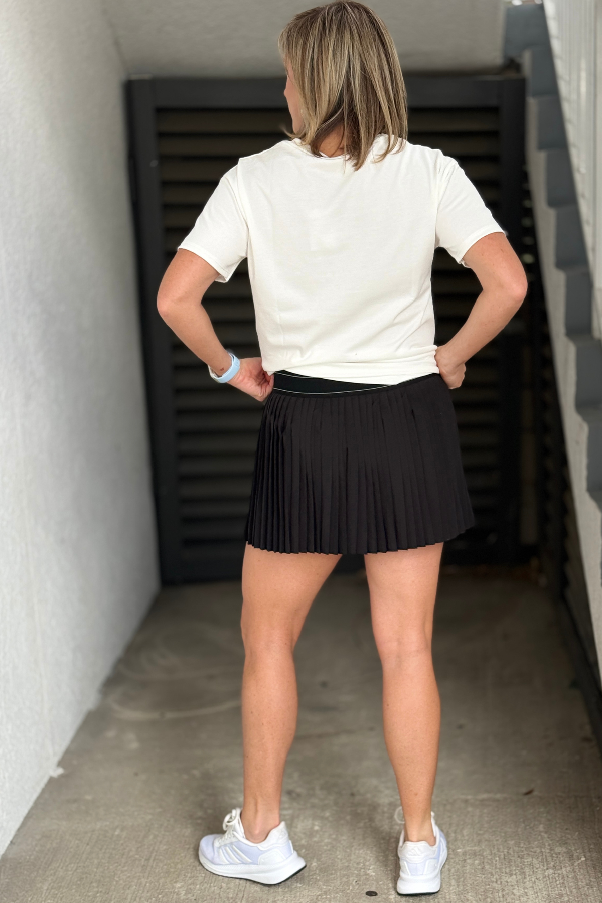 Black mini skort with knife pleat detail