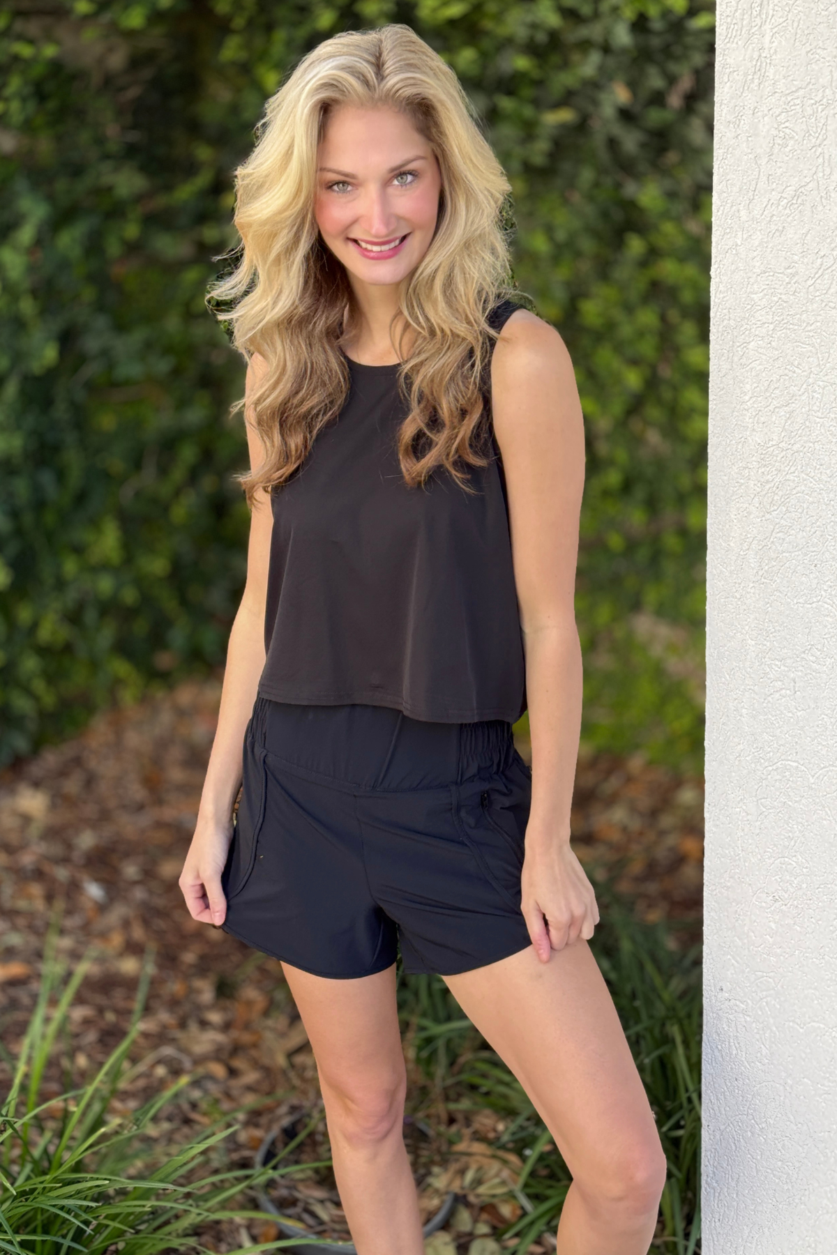 Black cropped tank top with snap keyhole detail front view