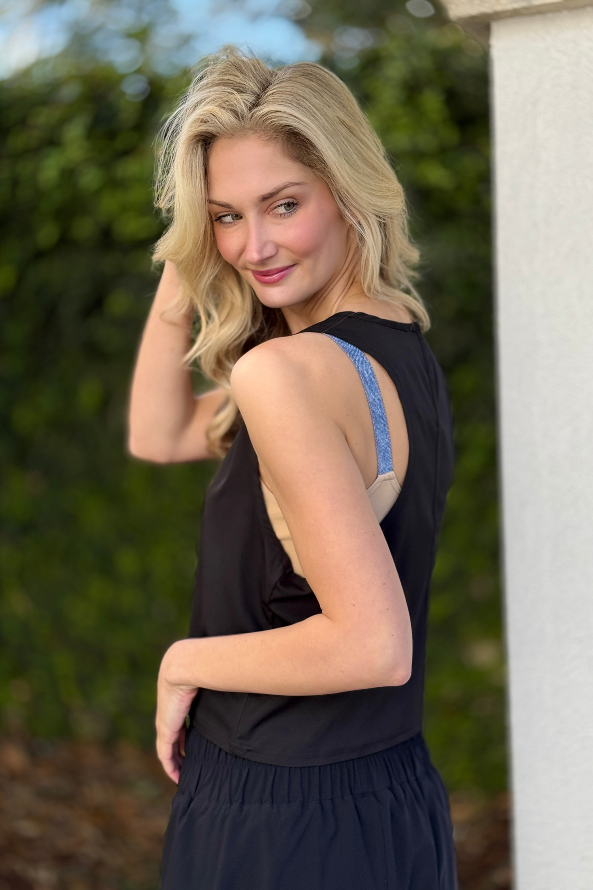 Close up of snap closure keyhole detail on black tank