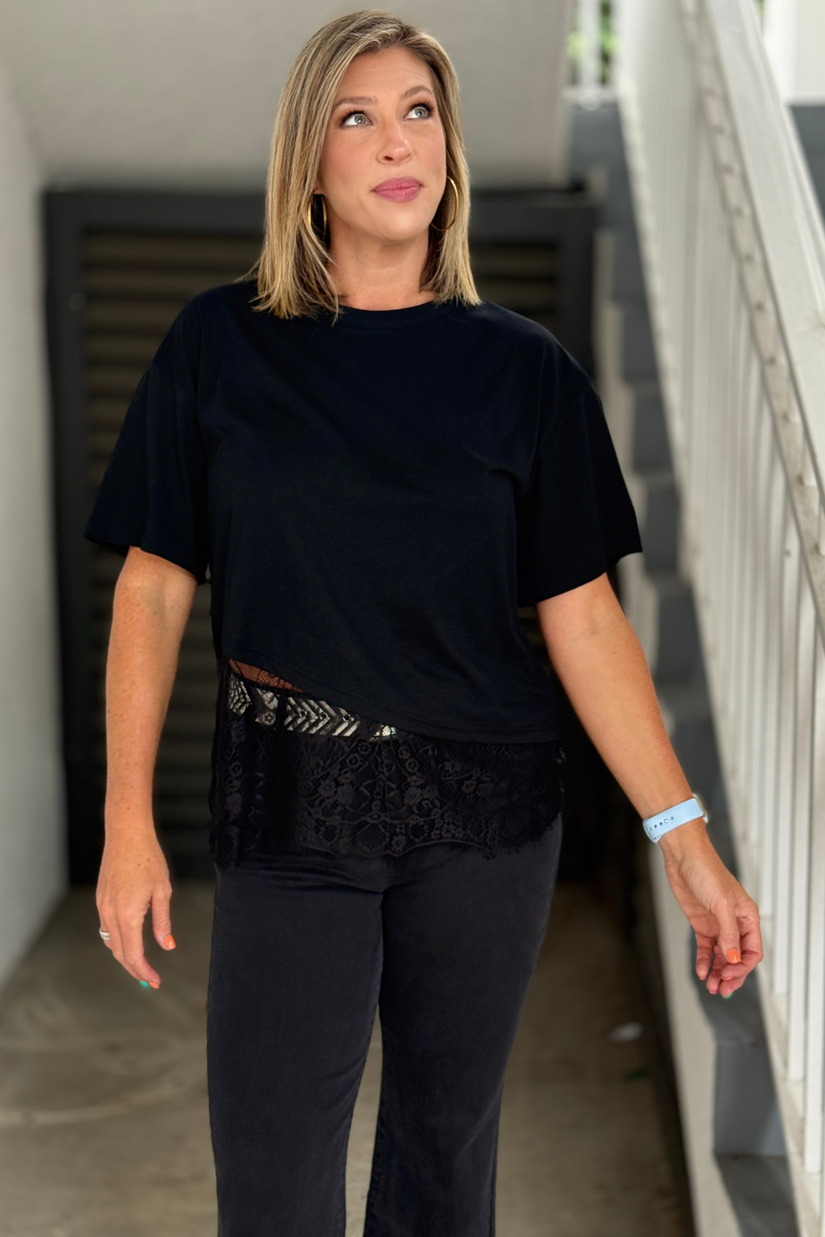 Women's relaxed fit black tee with floral lace hem