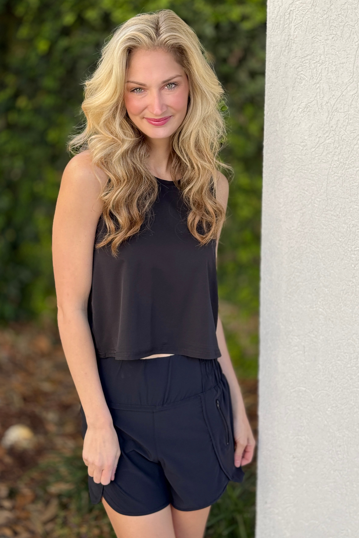 Loose fit black cropped athletic tank styled with active shorts