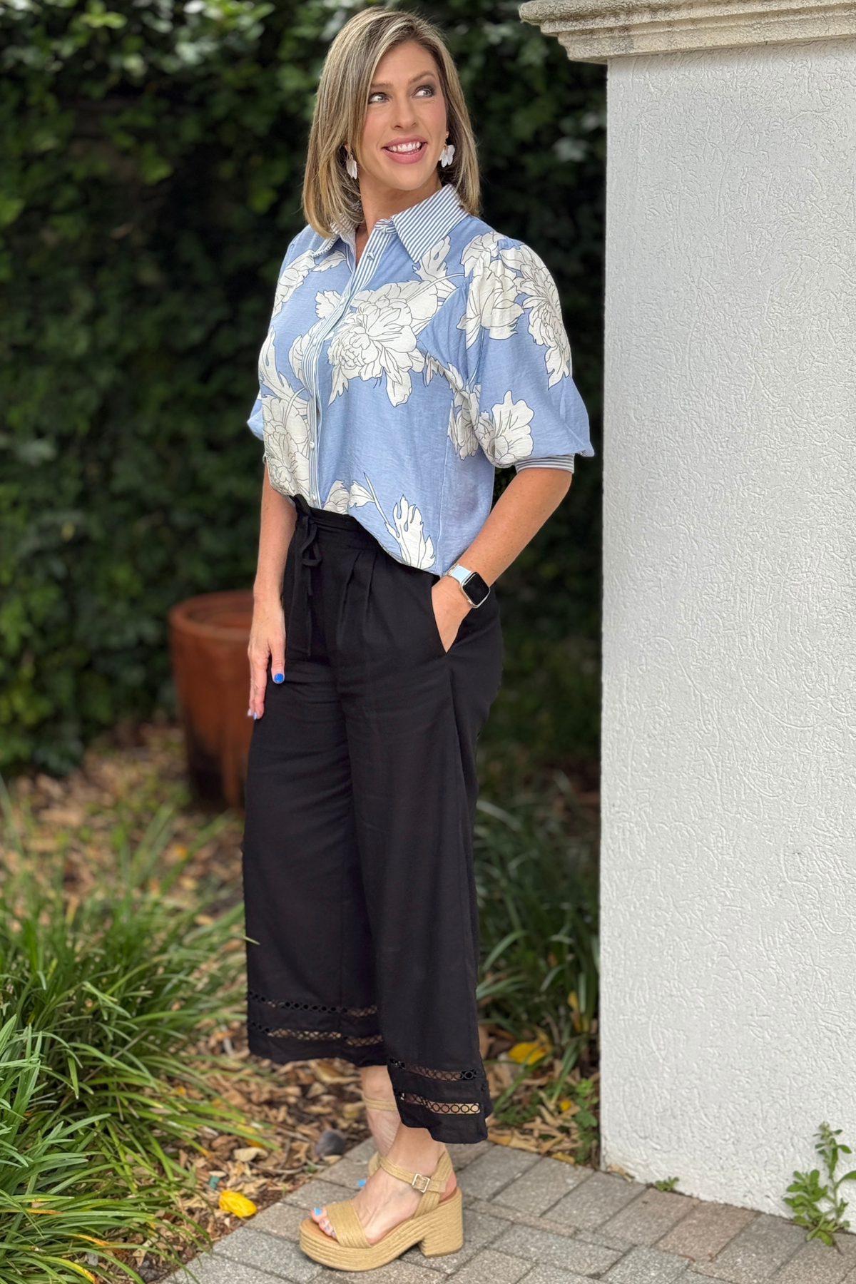 Side view of black linen wide leg pants with trim detail