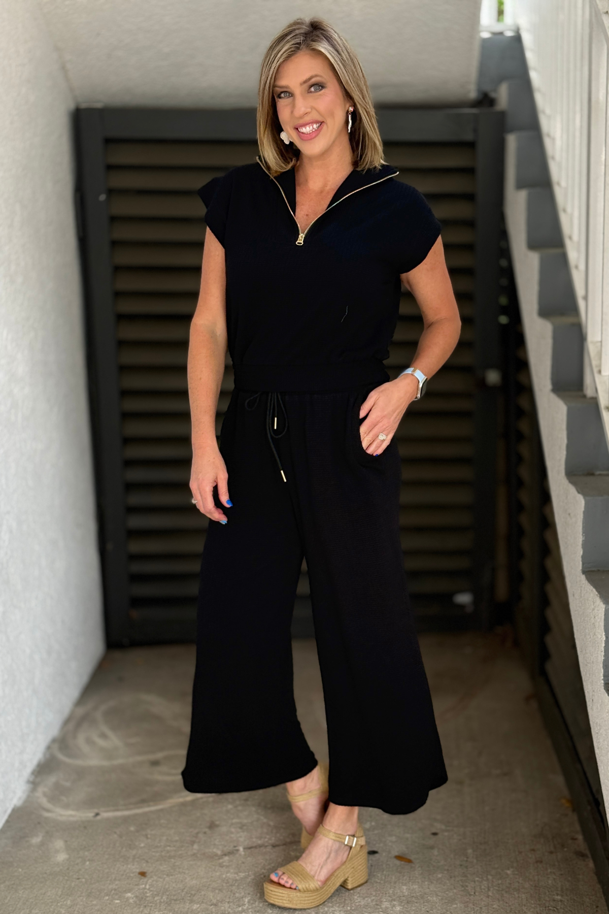 black textured knit lounge set with half zip top and drawstring pants