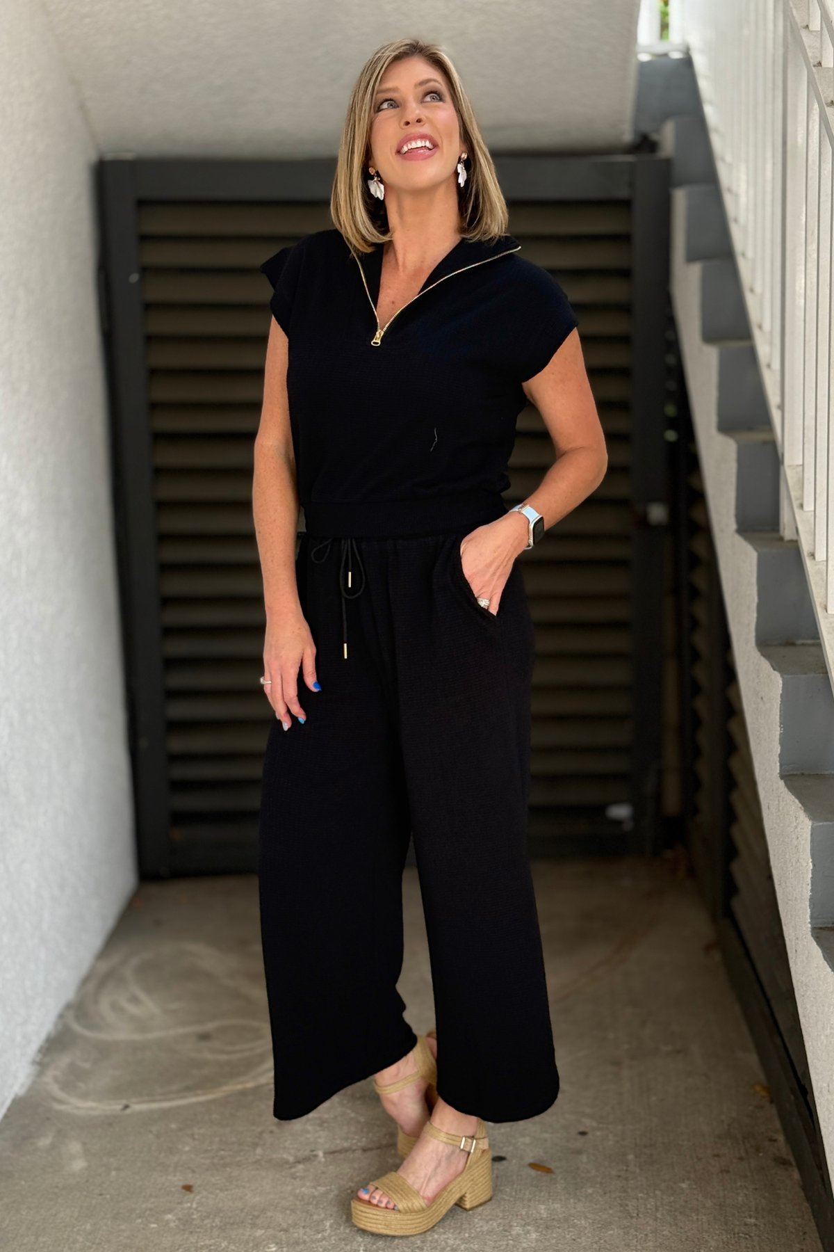 casual black lounge set outfit styled with sandals for summer