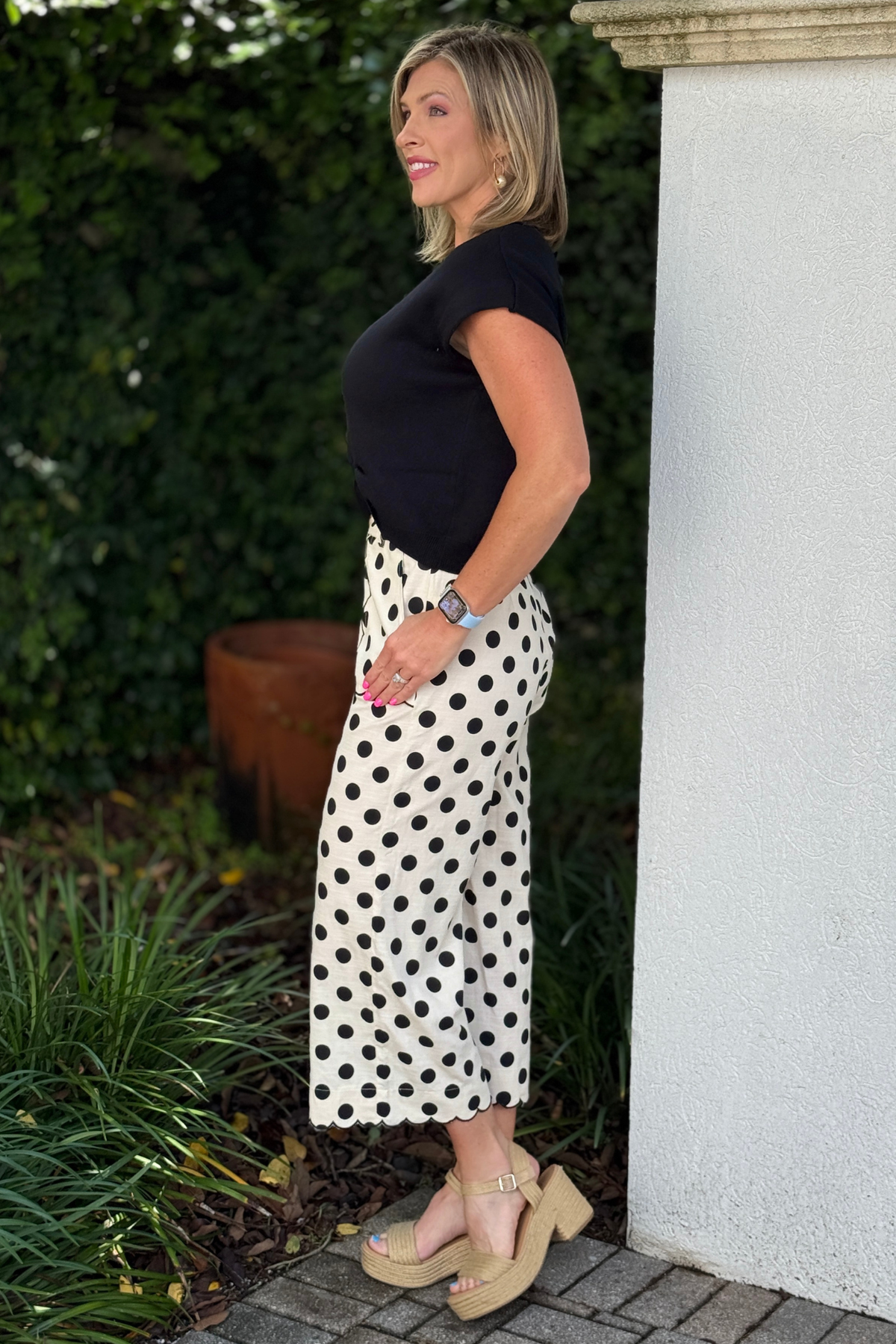 Chic polka dot pants paired with black sweater top