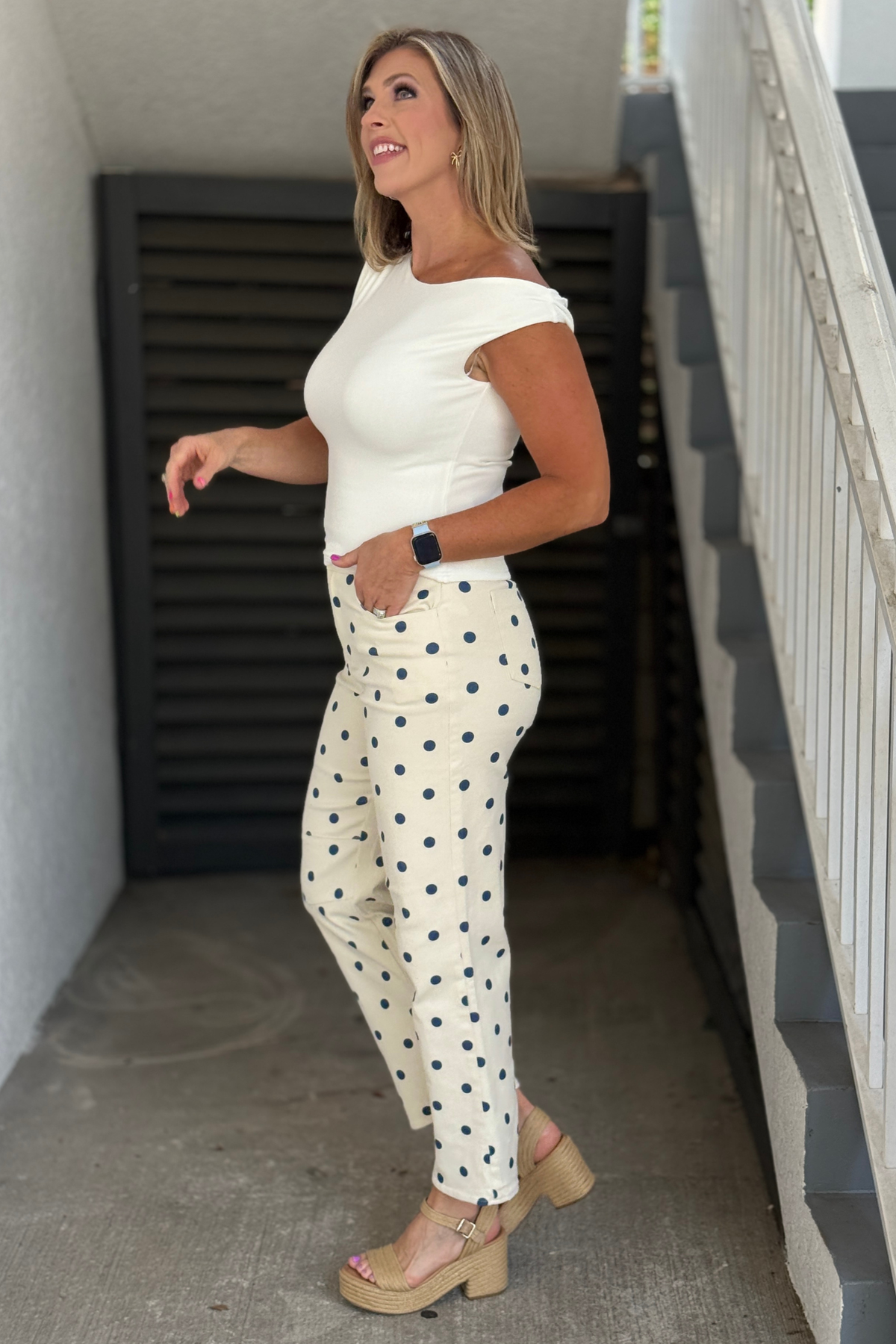 Boutique cream pants featuring classic navy polka dots