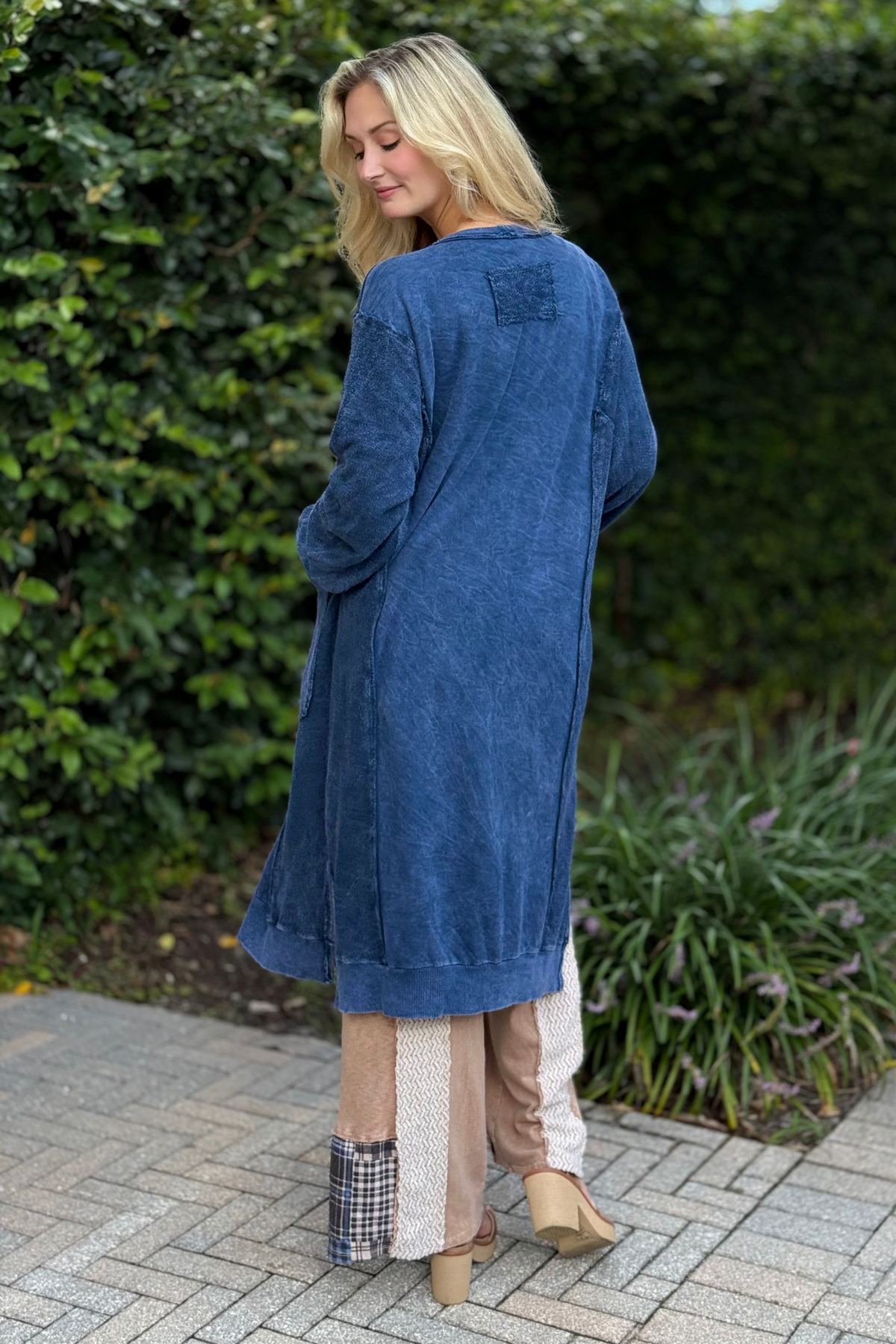Woman wearing Indigo Drift Cardigan in navy – oversized mineral wash French terry cardigan with buttons and side slits