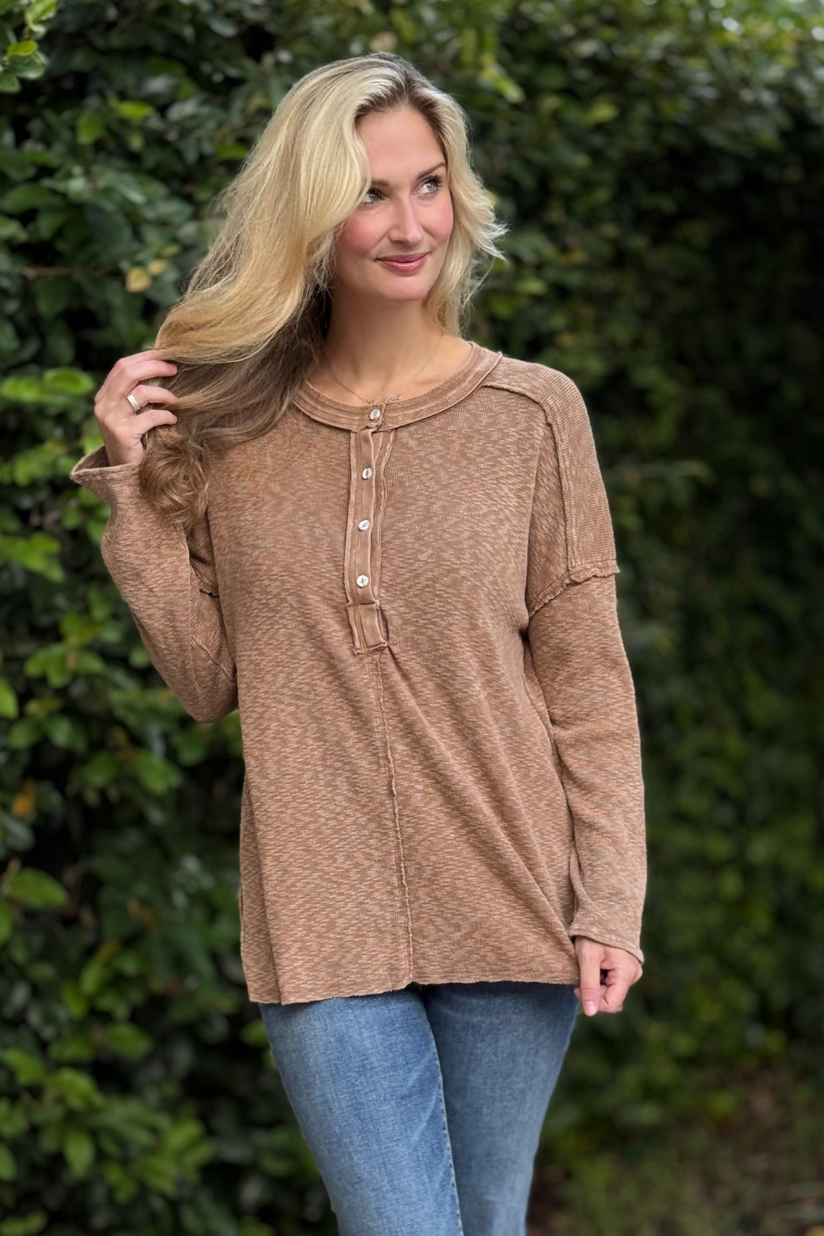Woman wearing Harvest Moon Henley Top in brown – lightweight boho knit long sleeve with button details.