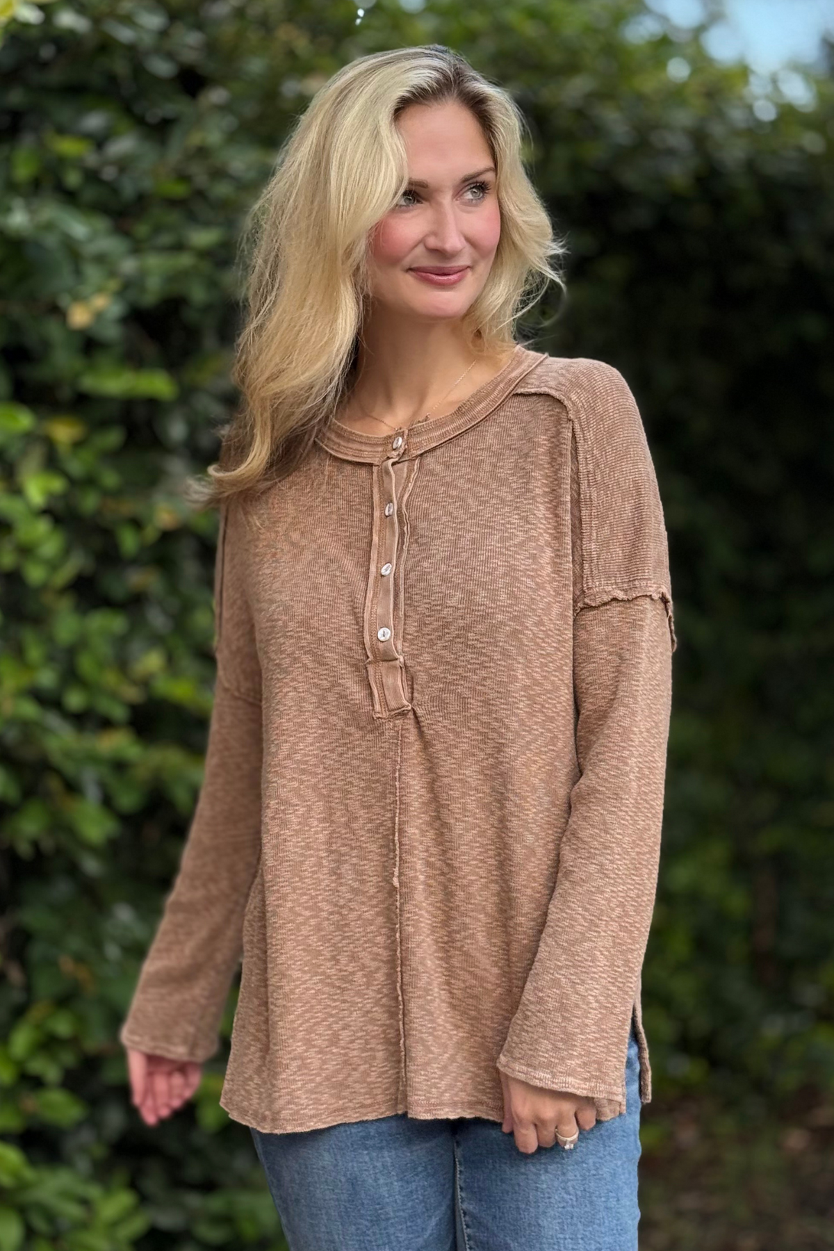 Woman wearing Harvest Moon Henley Top in brown – lightweight boho knit long sleeve with button details.