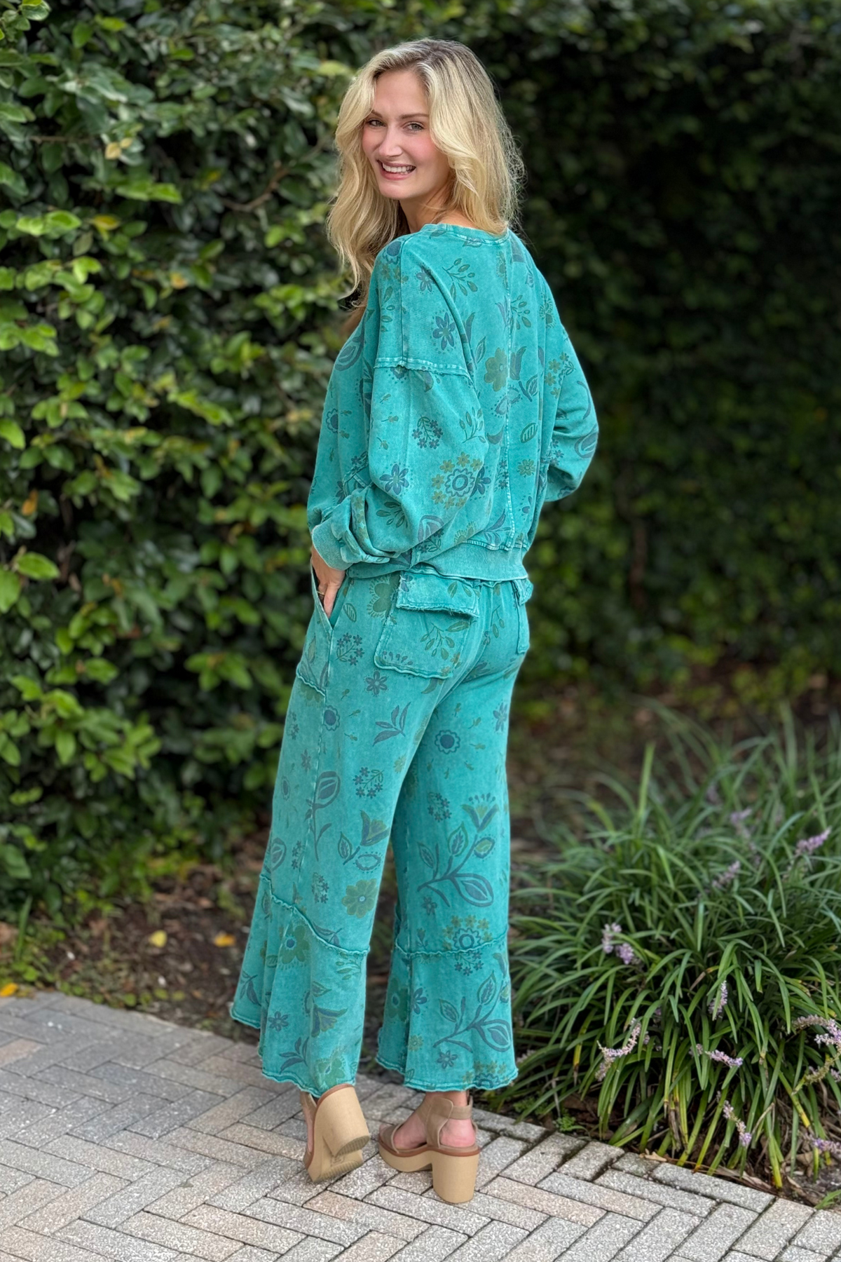 Floral printed washed terry pants with exposed seams and patch pockets