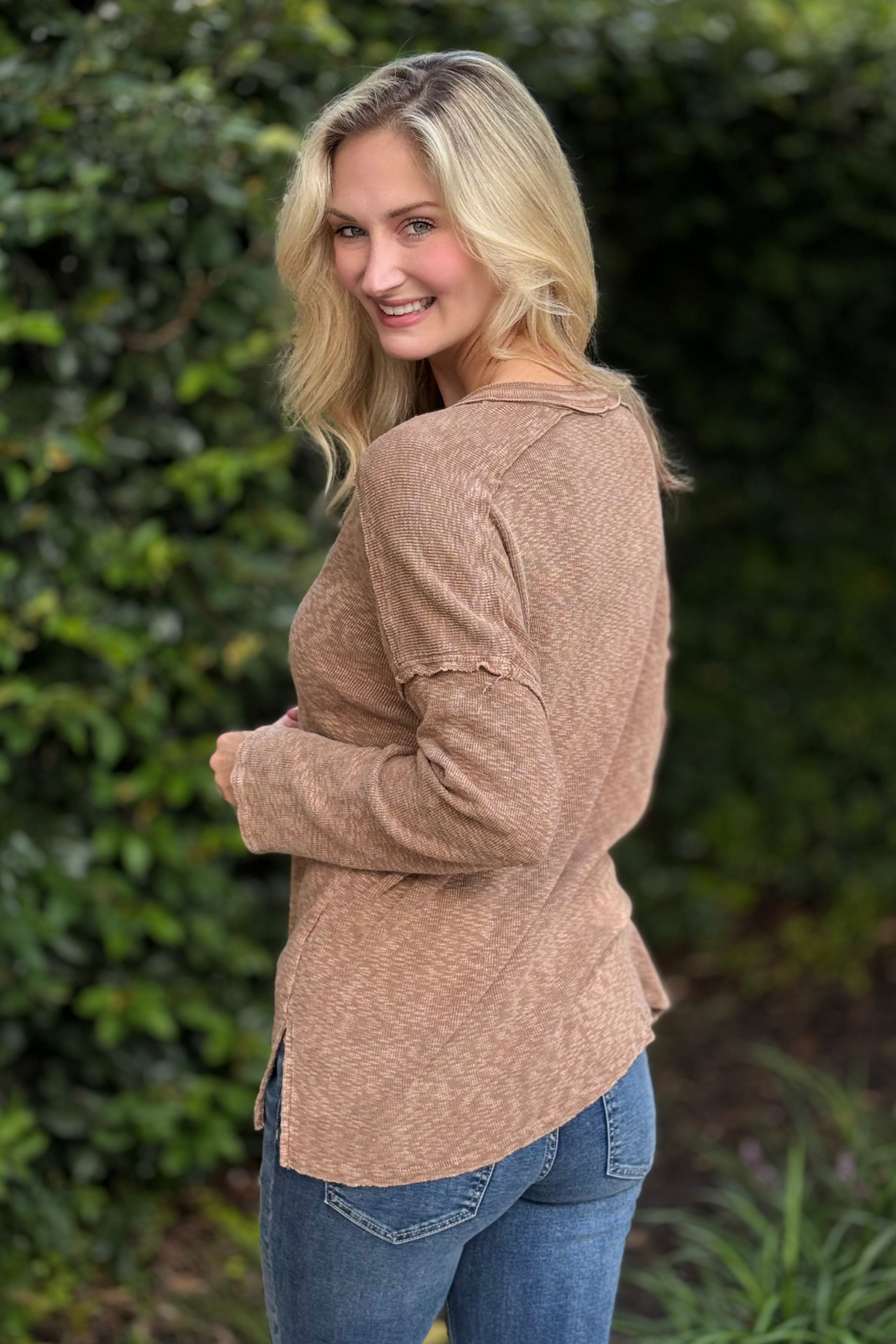 Woman wearing Harvest Moon Henley Top in brown – lightweight boho knit long sleeve with button details.