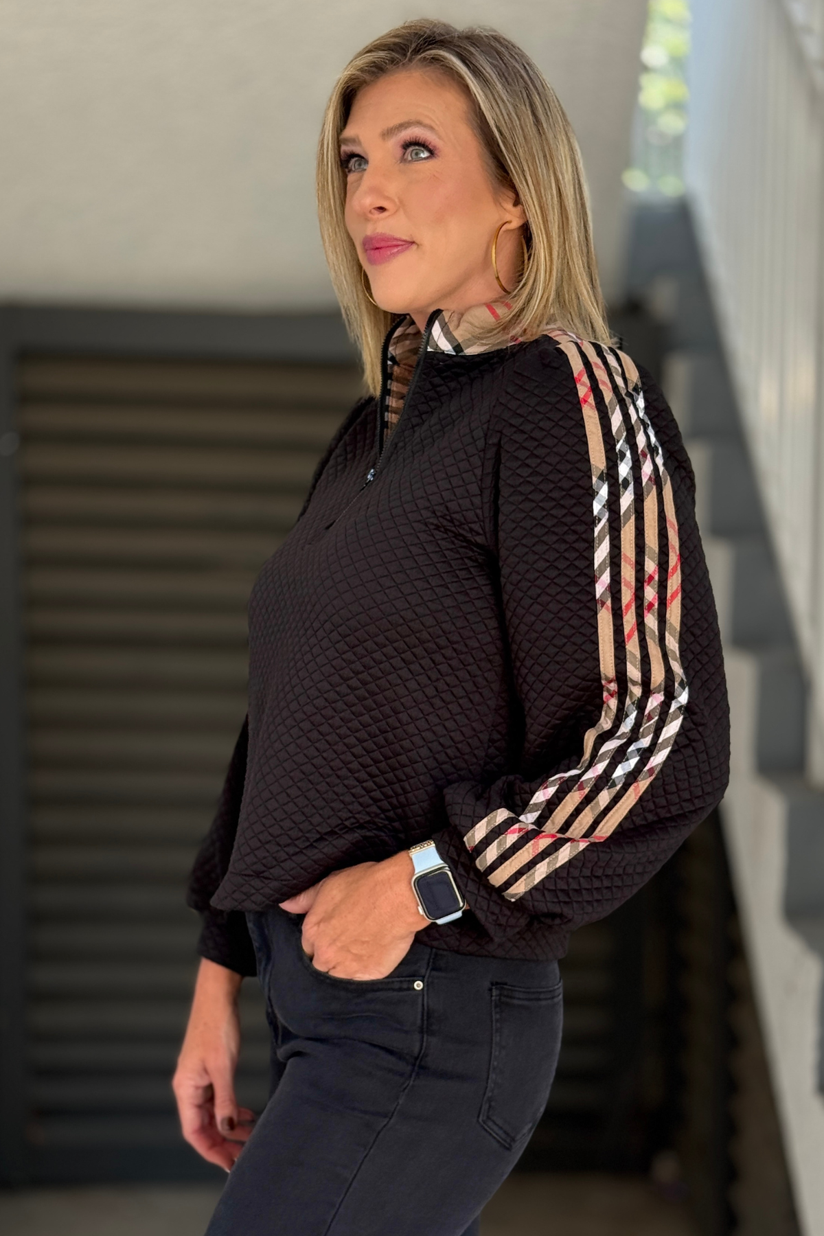Side view of black plaid detail textured pullover
