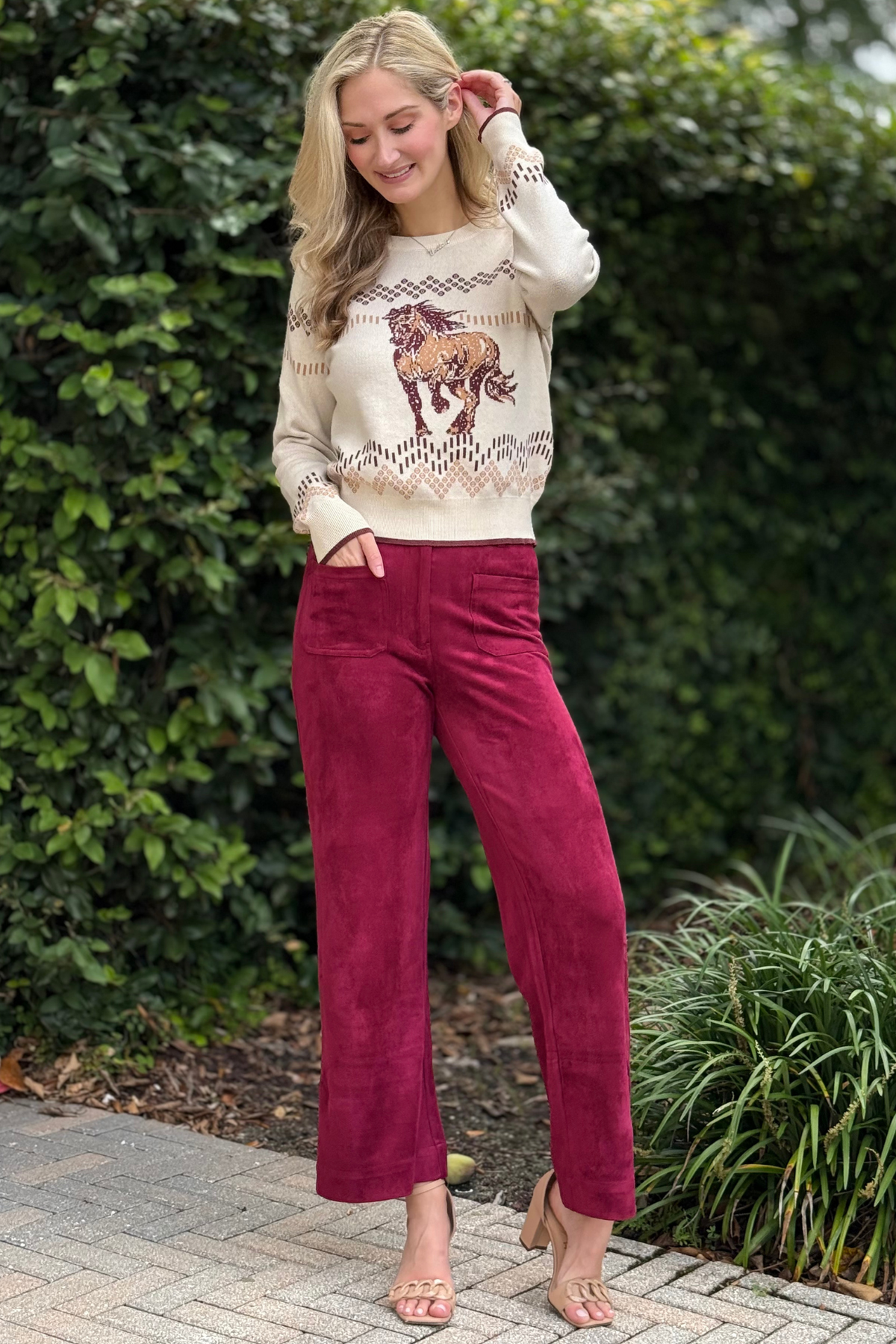 Close-up of burgundy faux suede pants showing soft texture