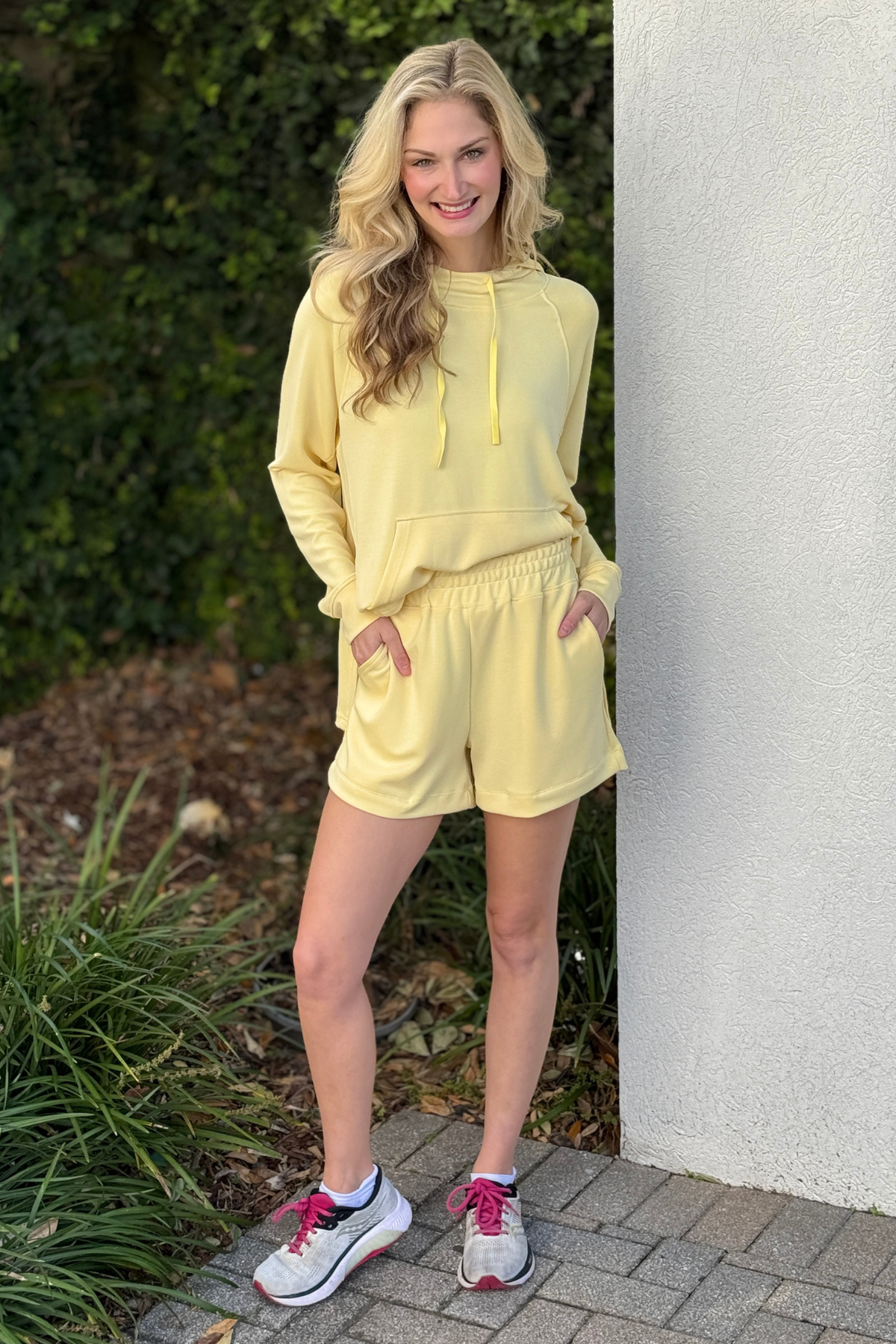 Back view of butter yellow Laguna Dune hoodie showing hood and longline silhouette