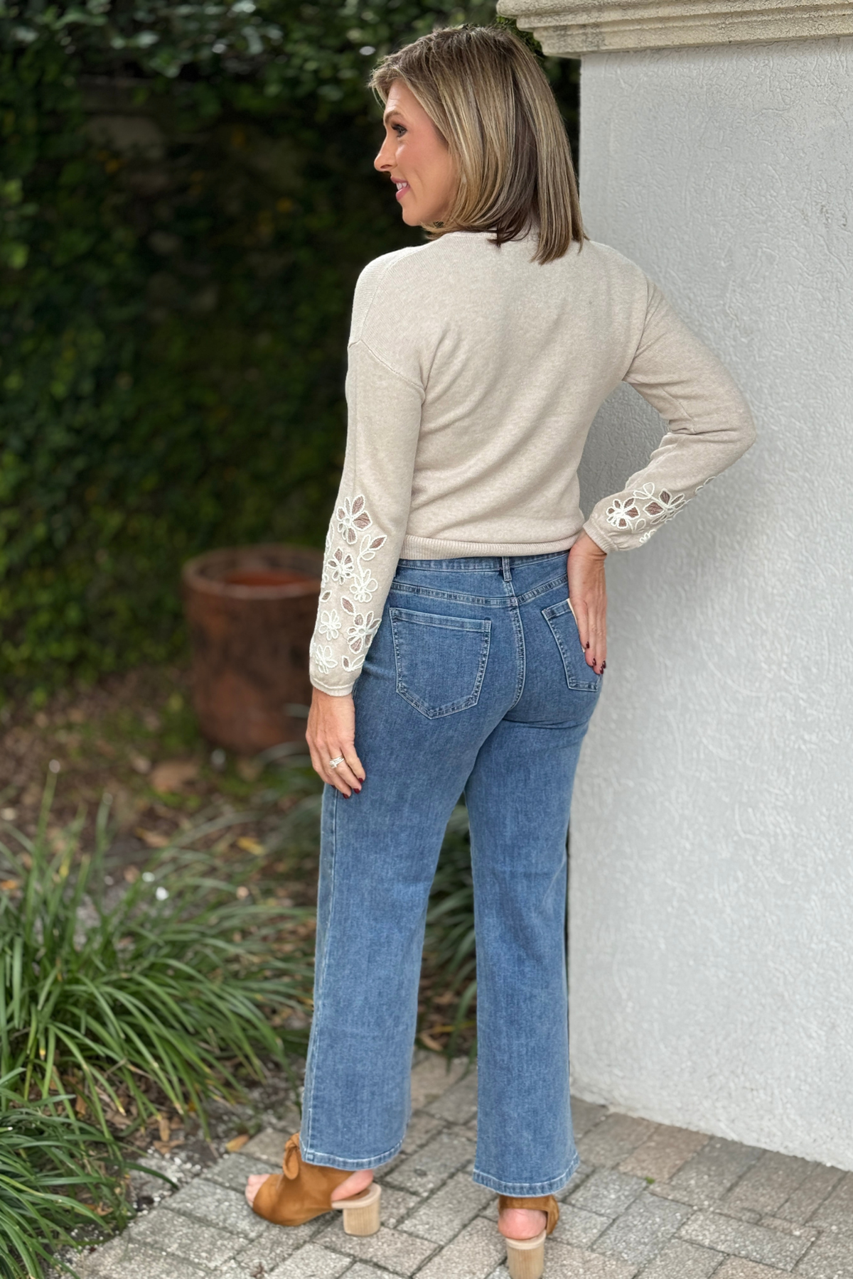 Charlie B rhinestone denim styled with neutral sweater