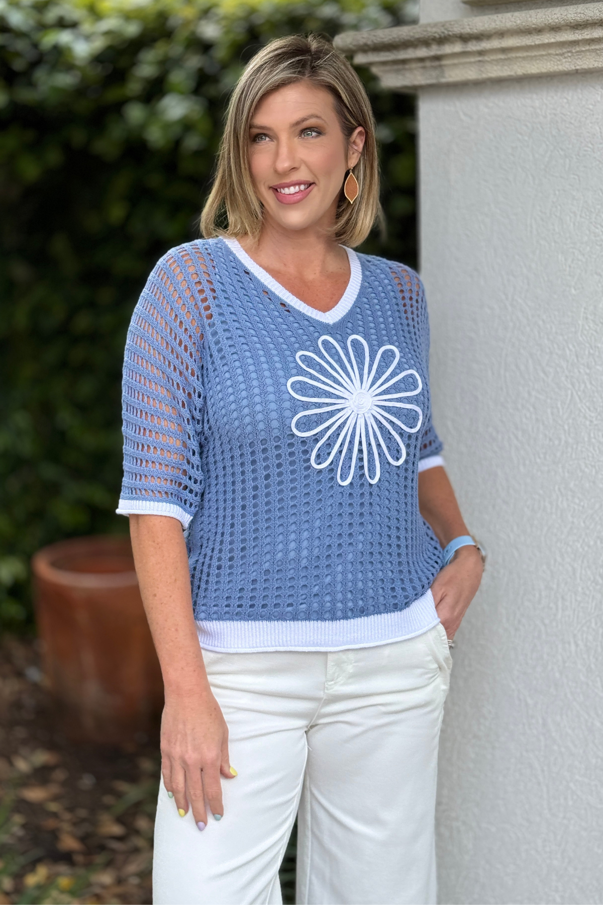 Lightweight blue open knit sweater paired with white pants