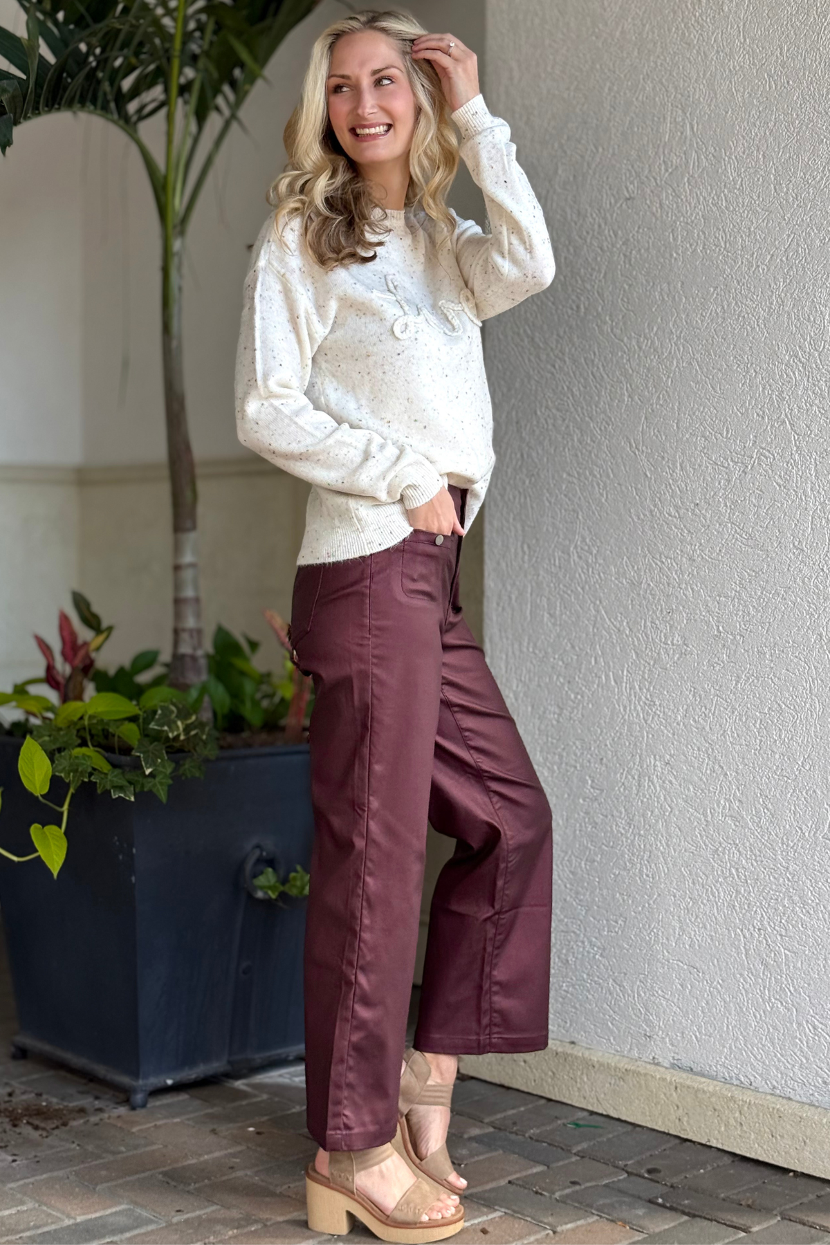 Side view of Charlie B Metallic Wax Flared Pants — rich Cabernet red with flattering cropped silhouette.
