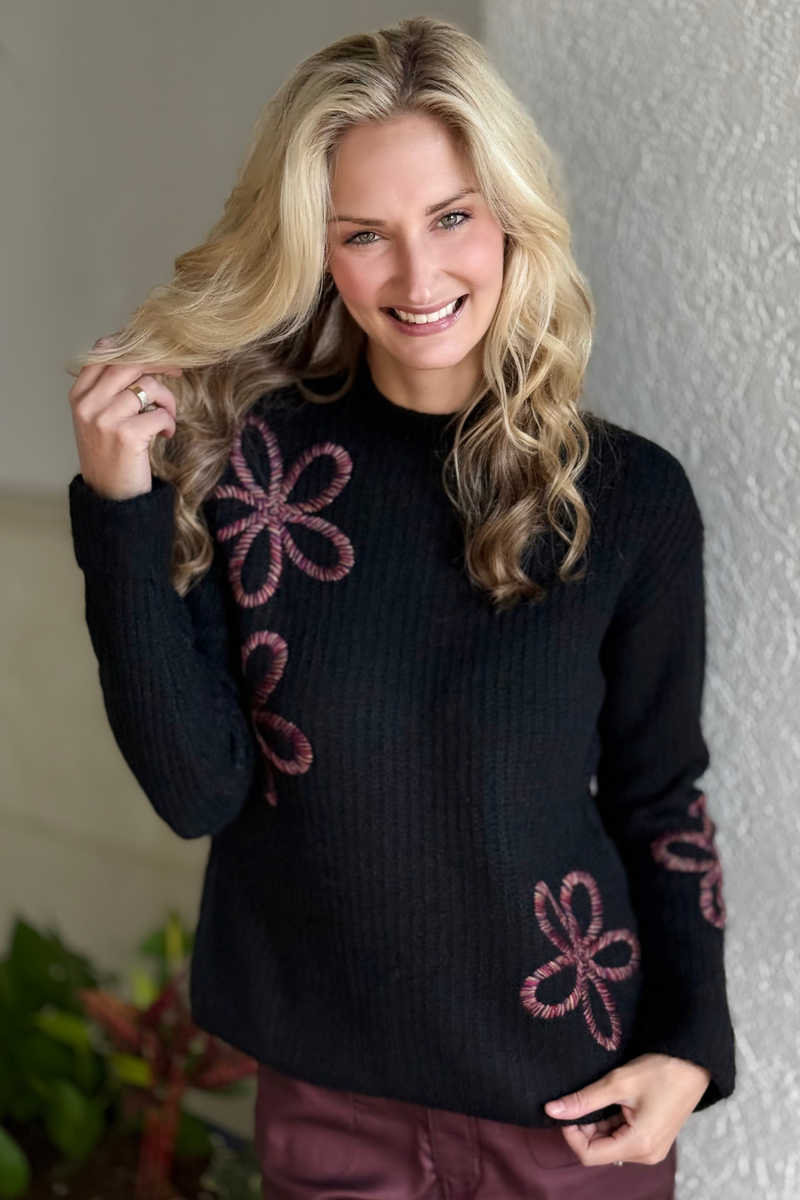Model wearing Charlie B black mock neck sweater with relaxed fit and wide cuffs.