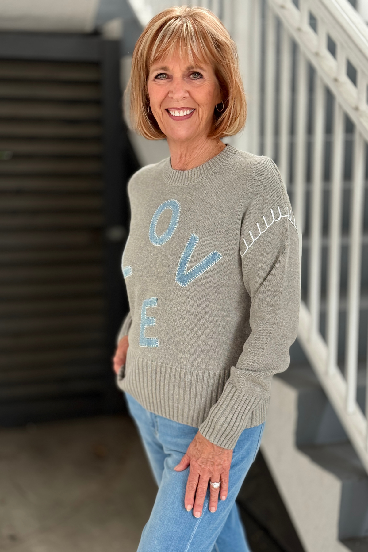 Back view of Charlie B grey crew neck sweater with ribbed hem