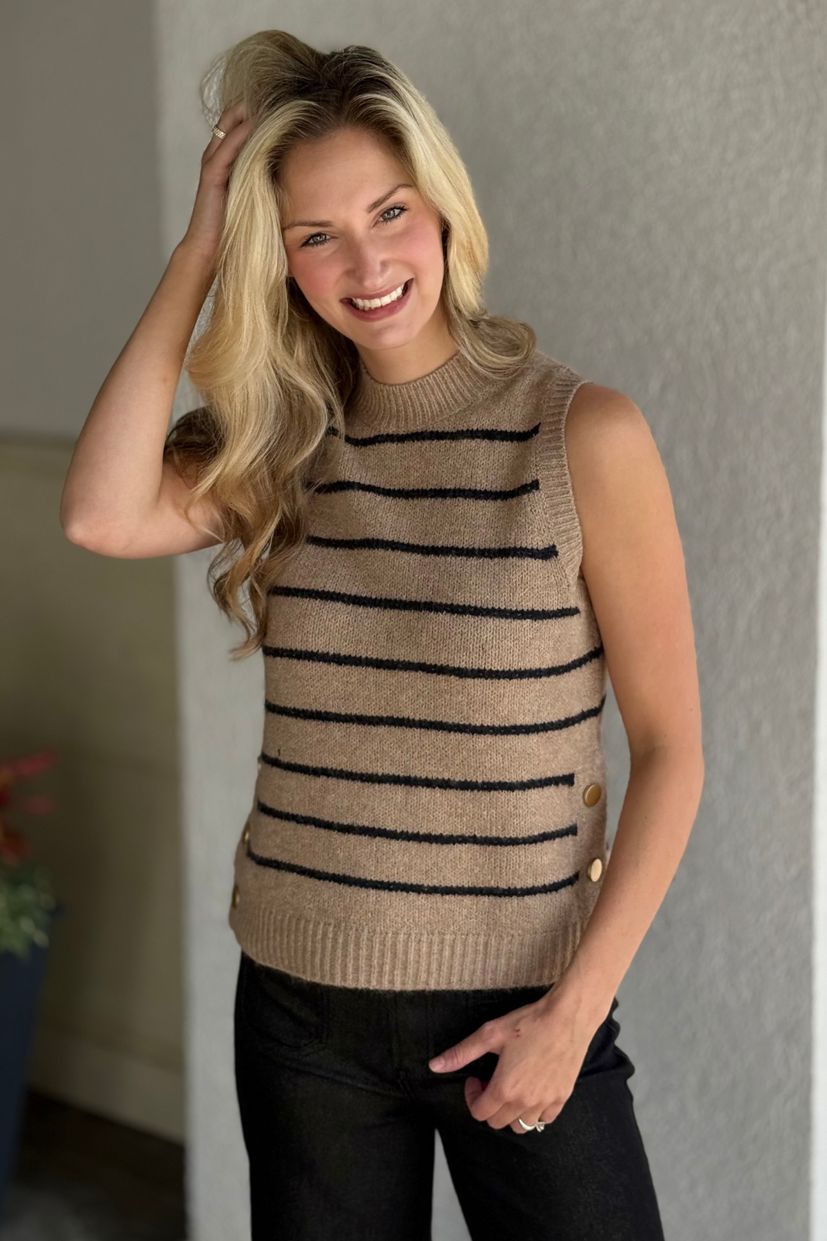 Model wearing Charlie B Round Neck Sweater Vest in Heather Camel layered over a blouse