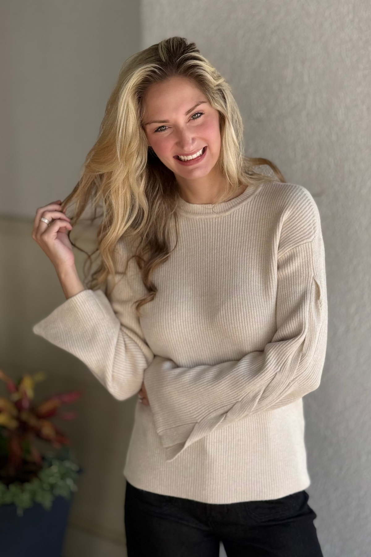 Woman wearing Charlie B oat crew neck sweater with cable sleeve detail