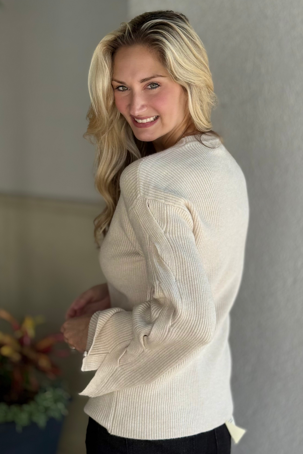 Close-up of Charlie B ribbed knit sweater in H. Oat with cable design on sleeves