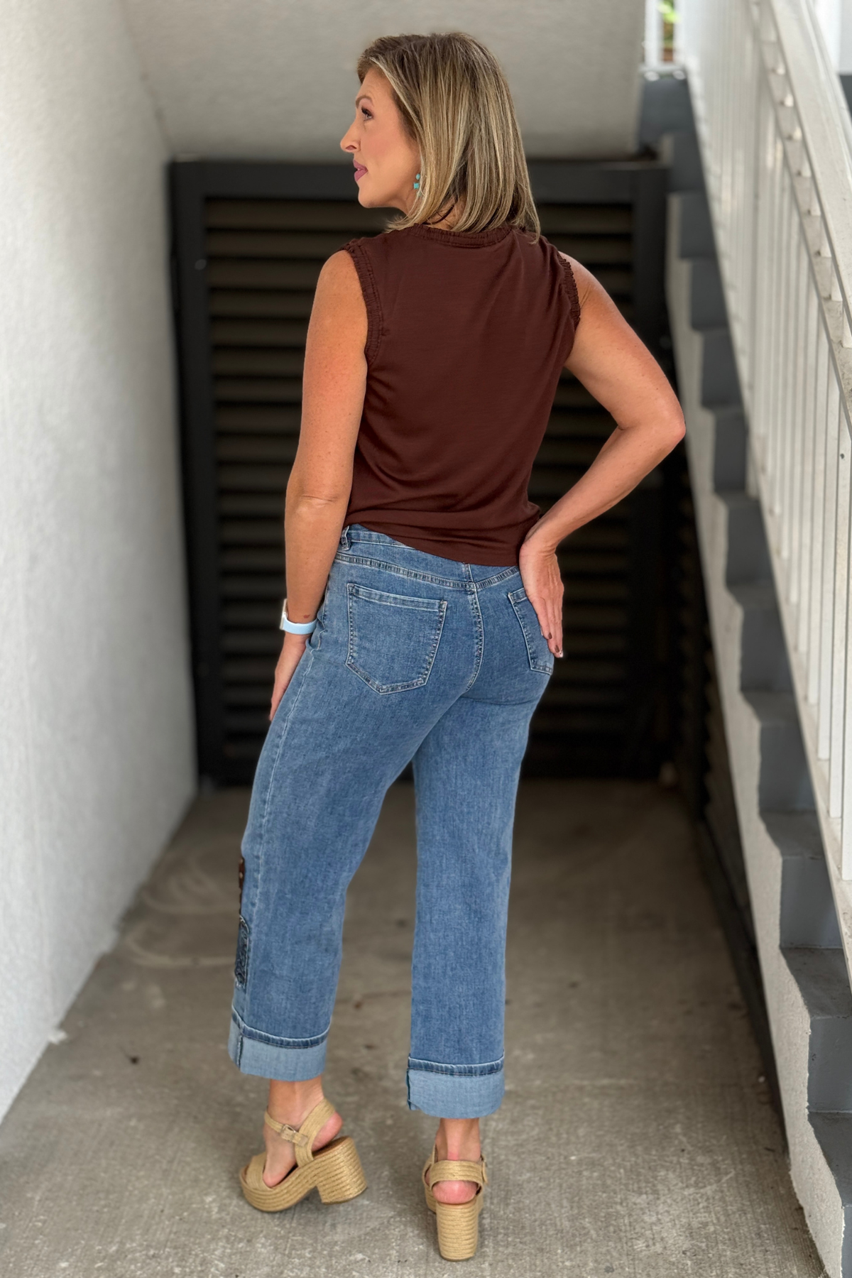 Medium blue cuffed straight jeans with plaid scarf accessory