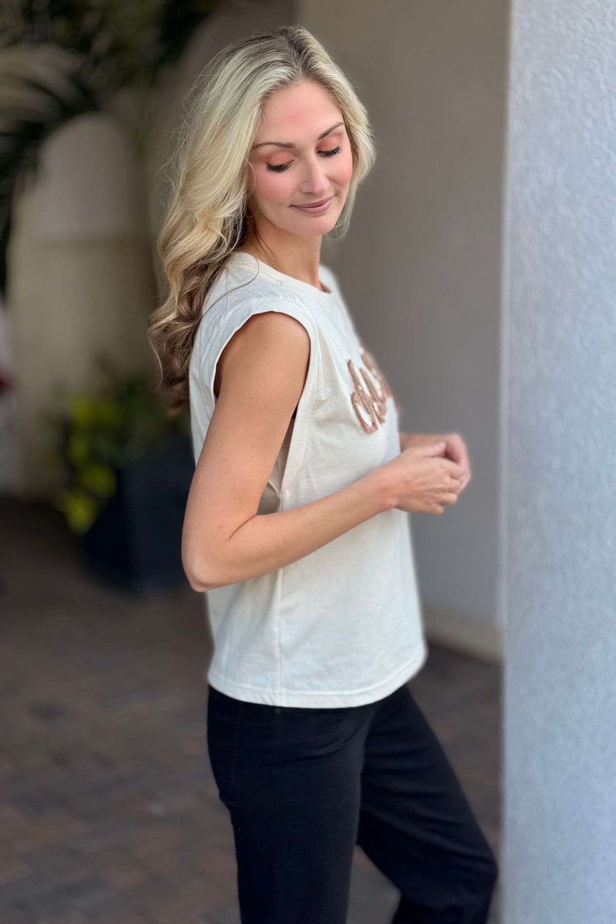 Detail shot of cheers embroidery with sequins