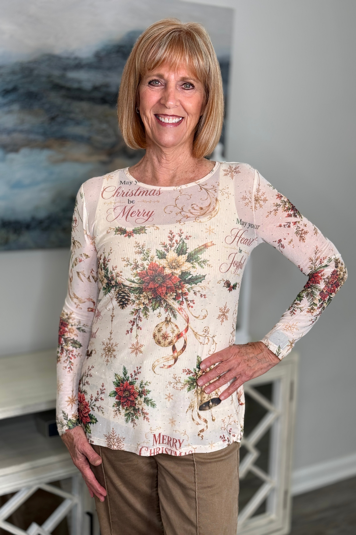 Ivory holiday mesh top with red green and gold Christmas print

