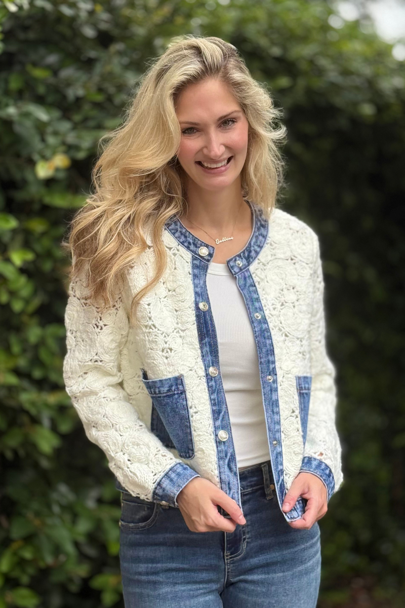 Close-up of Tribal crochet jacket showing floral crochet pattern and denim details